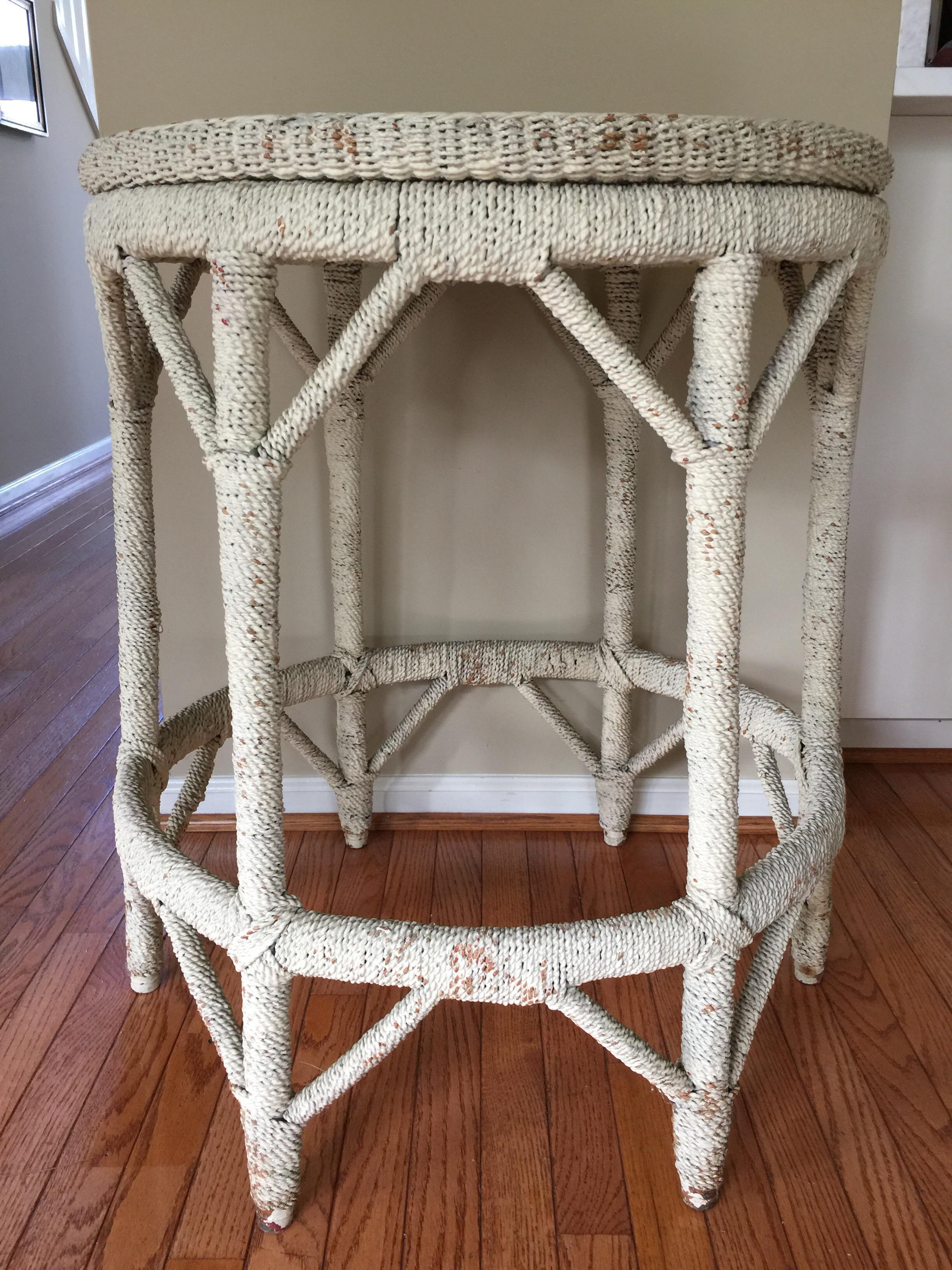 Tall round whitewashed wicker/rattan-like rope wrapped center hall entry table. This sturdy sculptural table can be used as a side, end accent table or bedside table. A transitional table that can be used in nautical or shabby chic beachy interiors.