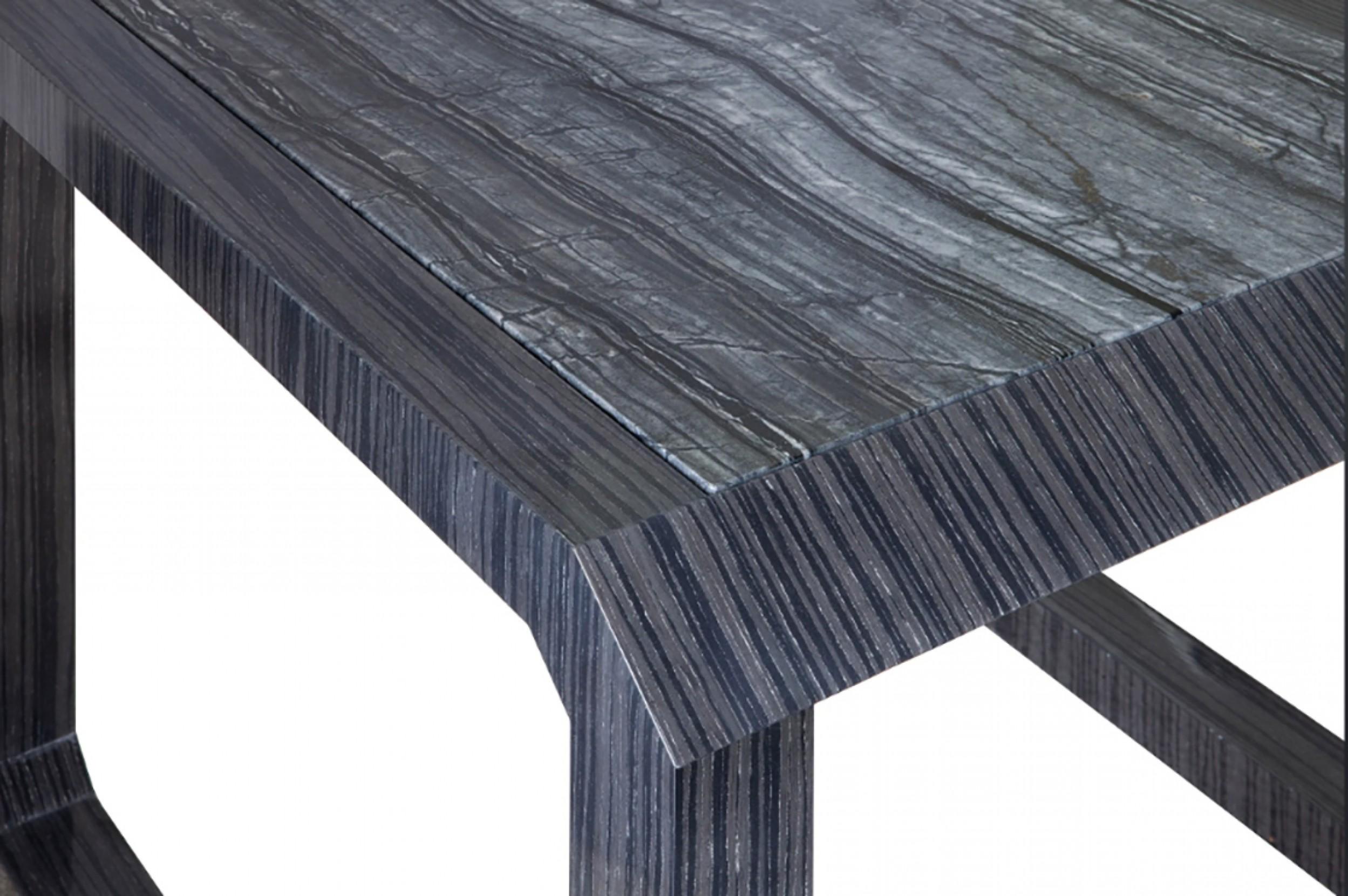 Contemporary American side table with chamfered corners, dark wood veneer frame, and dark marble top (RORIC TOBIN)

Condition: Good; Wear consistent with age and use