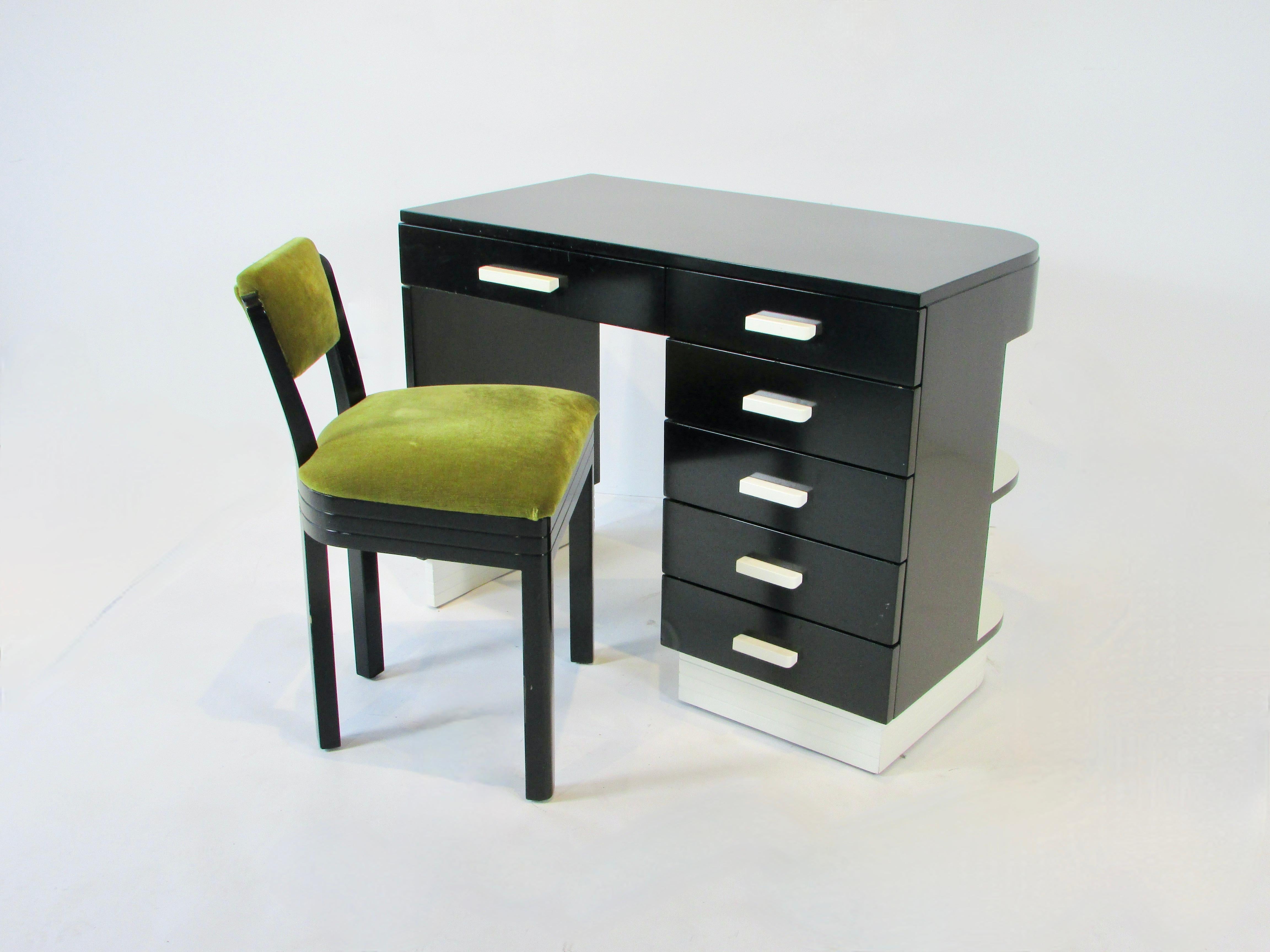 Manufactured by obscure Rorimer Brooks co. of Cleveland Ohio . Art Deco or Moderne Writing desk in matte black lacquer with cream accents . Bank of five drawers to users right side additional pencil drawer over kneehole . Attractive from any angle