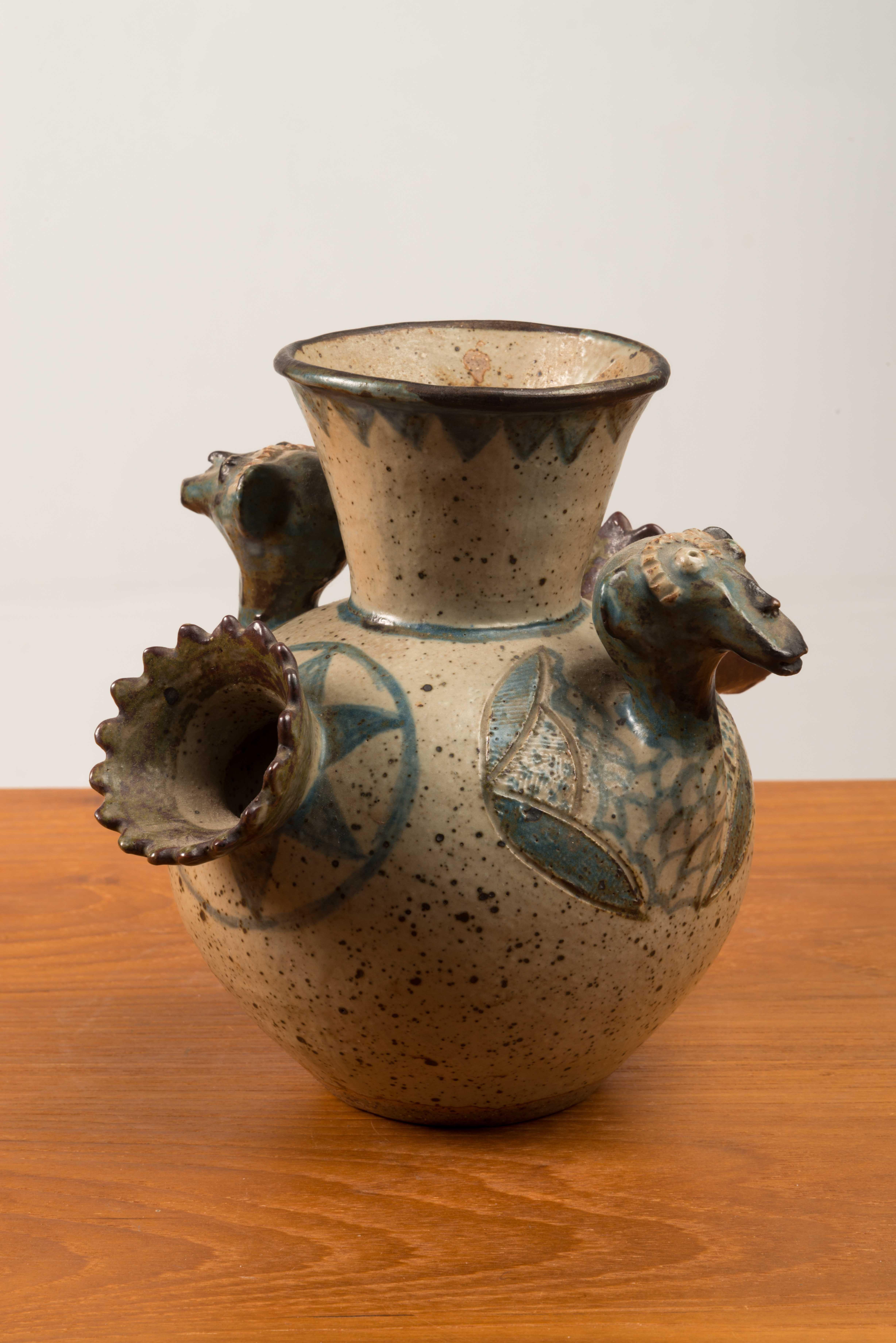 This hand-build stoneware vase was made by Euriel Damane (née Mbatha) in at the Rorke's Drift ceramic studio in KwaZulu Natal, South Africa in 1988. The studio was founded in 1966.
The vase is decorated with a stylised animal head.
Rorke's Drift