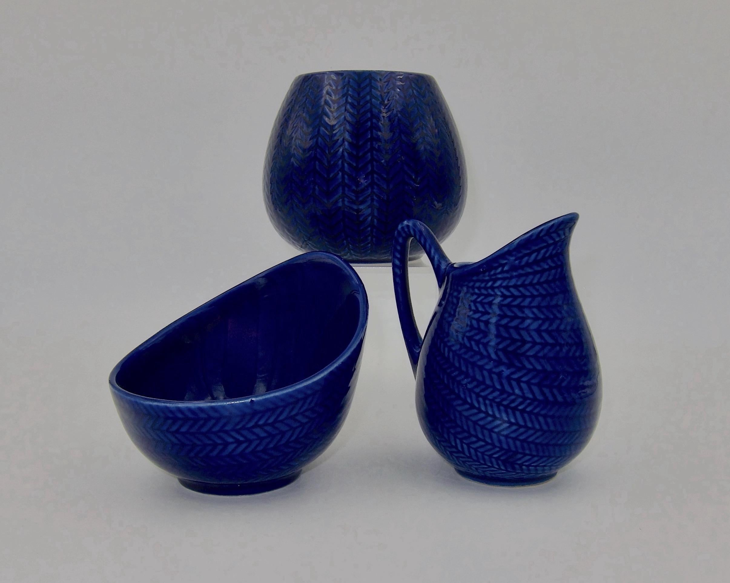 Three Scandinavian Blå Eld / blue Fire midcentury tableware items designed in 1949 by Hertha Bengtson (1917-1993) and manufactured by the Rörstrand Porcelain Factory of Sweden from 1951 to 1971. The Blå Eld line of creamware is considered a