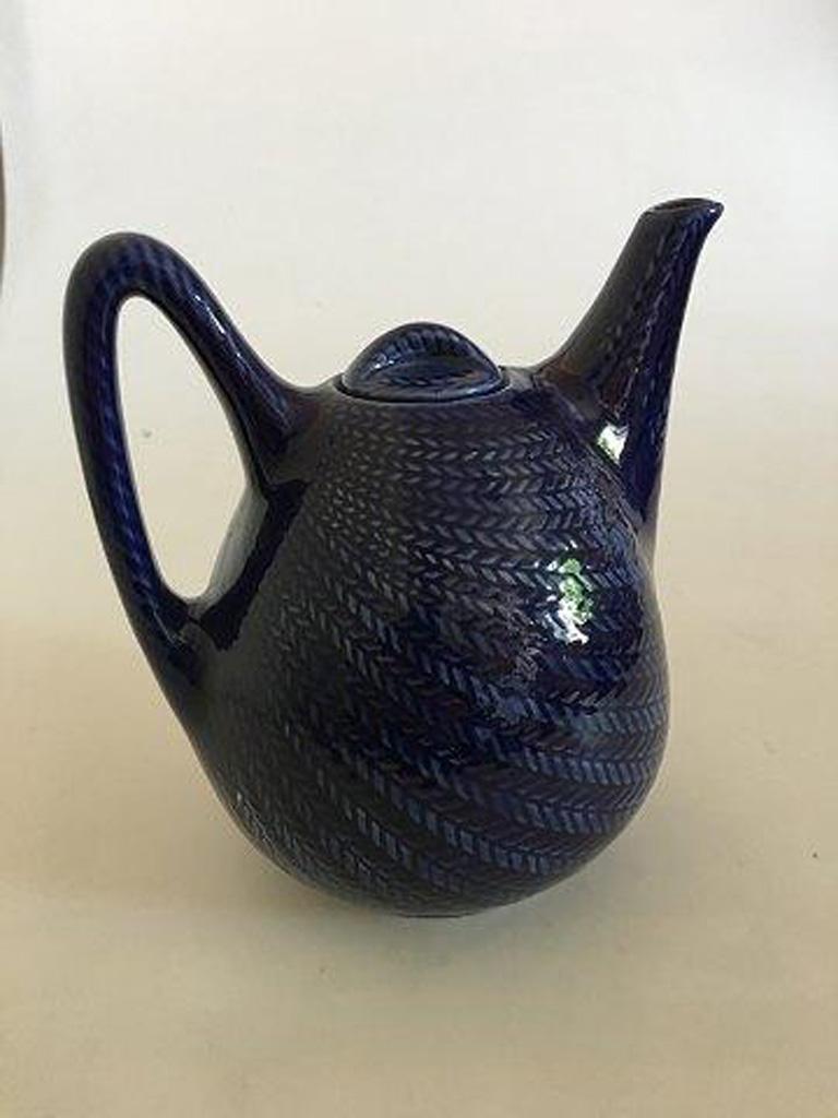 Rorstrand blue eld / blue fire teapot. 

Blue Eld / Blue Fire designed by Hertha Bengtsson manufactured by Rorstrand from 1950 to 1971. It has a great retro shape and decorated with a brilliant herringbone in a gorgeous blue high gloss glaze.