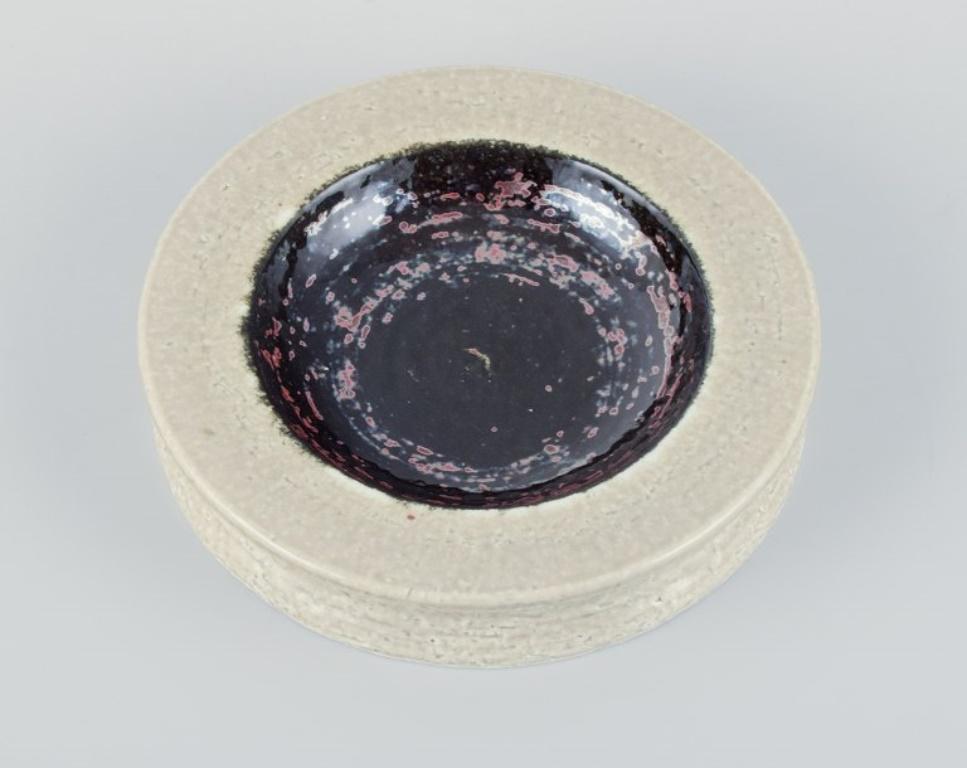 Rörstrand, Sweden, ceramic bowl in cream and black metallic glaze.
From the 1960s.
Perfect condition.
Marked.
First factory quality.
Dimensions: Diameter 17.5 cm x Height 3.3 cm.