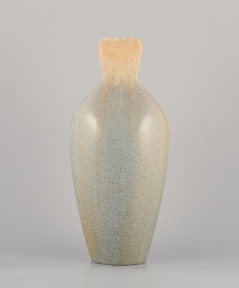 Rörstrand, Sweden. Colossal faience vase. Hand-glazed in green, yellow, and blue hues.
Approximately from the 1920s.
Stamped with the blue Rörstrand mark.
In very good condition with natural cracks.
Dimensions: Height 43.5 cm x Width 18.0 cm.