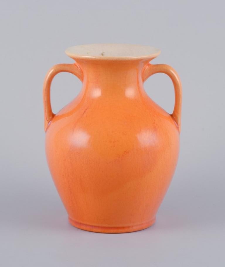 Rörstrand, Sweden, earthenware vase with handles in uranium yellow glaze.
Early 20th century.
Marked.
In excellent condition.
Dimensions: H 14.5 cm x D 12.0 cm.