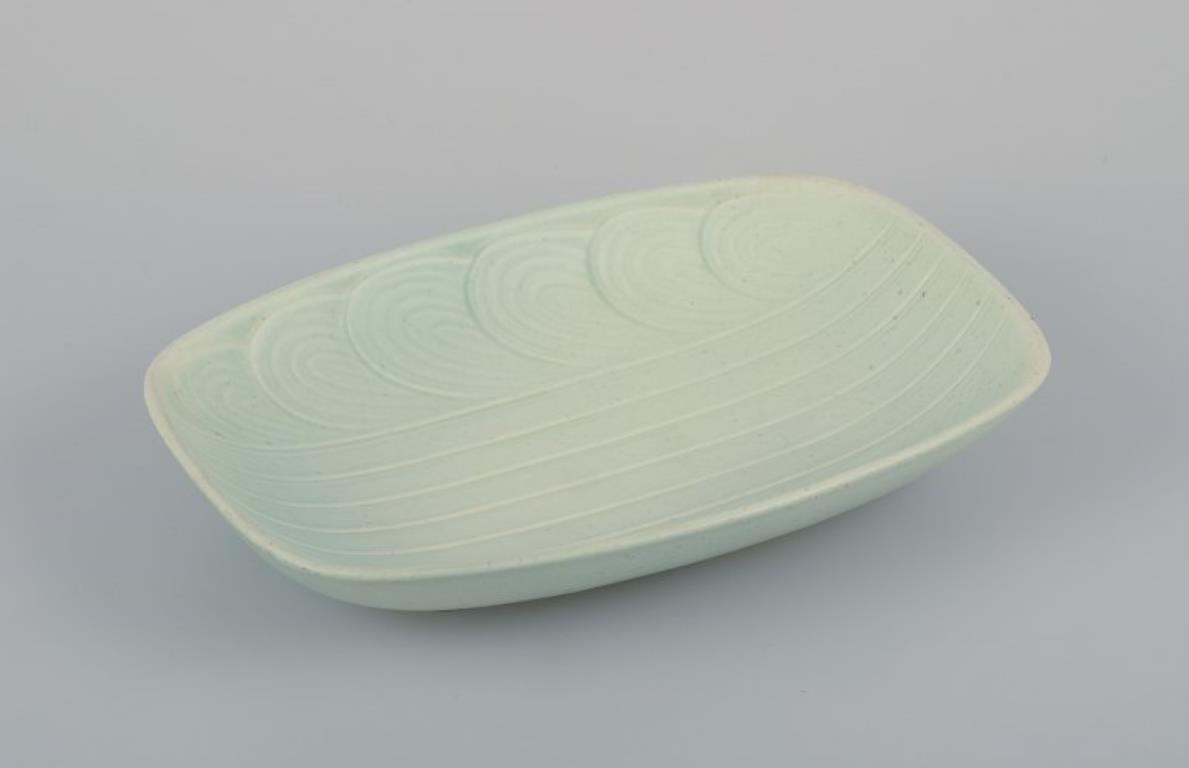Rörstrand, Sweden. Large ceramic bowl in a modernist design. Rare model. Glaze in light green tones.
Mid-20th century.
Perfect condition.
Marked.
First factory quality.
Dimensions: L 28.7 cm x W 19.4 cm x H 5.0 cm.