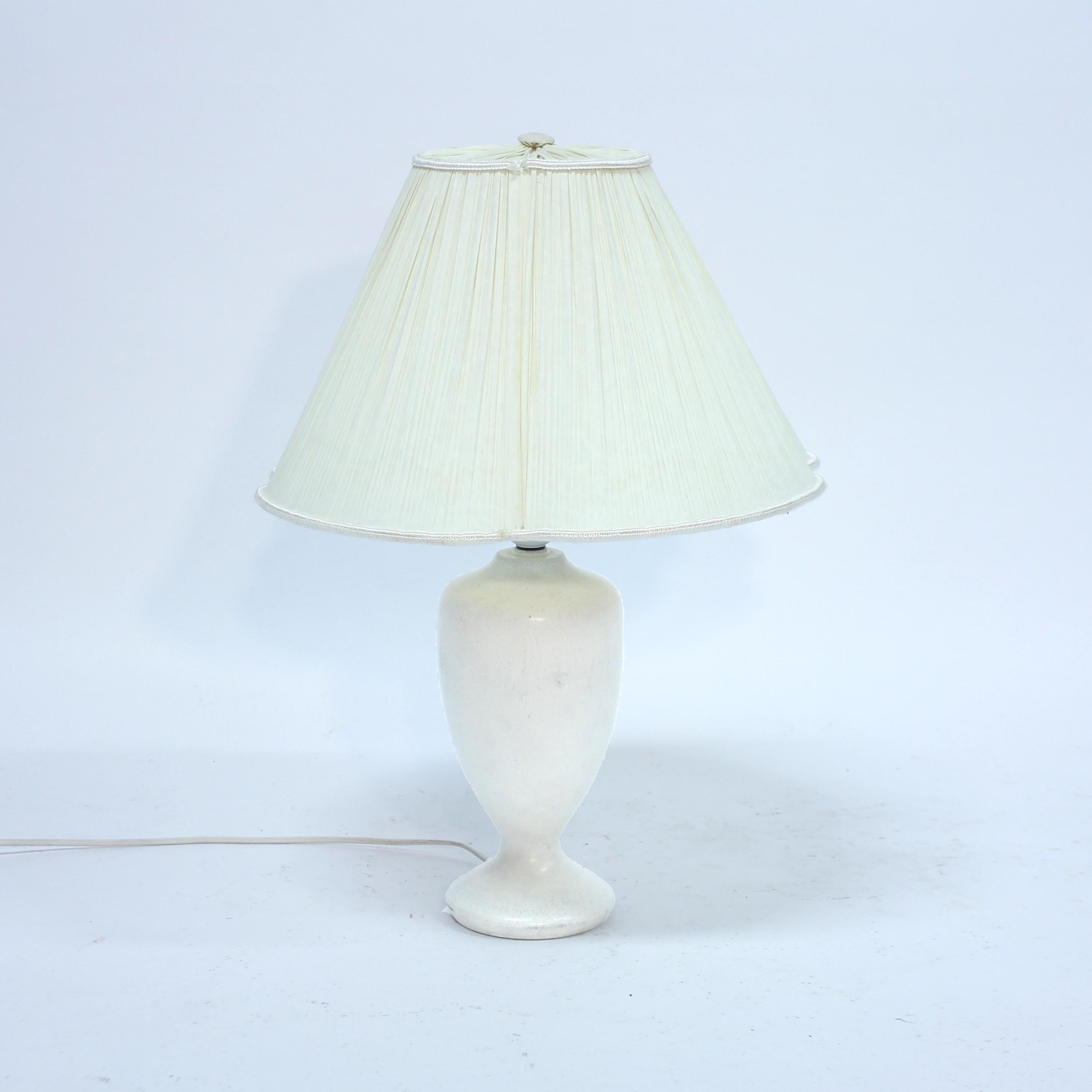 White stoneware lamp with small hints of grey, produced by Swedish manufacturer Rörstrand in the 1950s. Possibly deigned by Gunnar Nylund. The lamp is in an overall good vintage condition with light normal ware consistent with age and use. It has a
