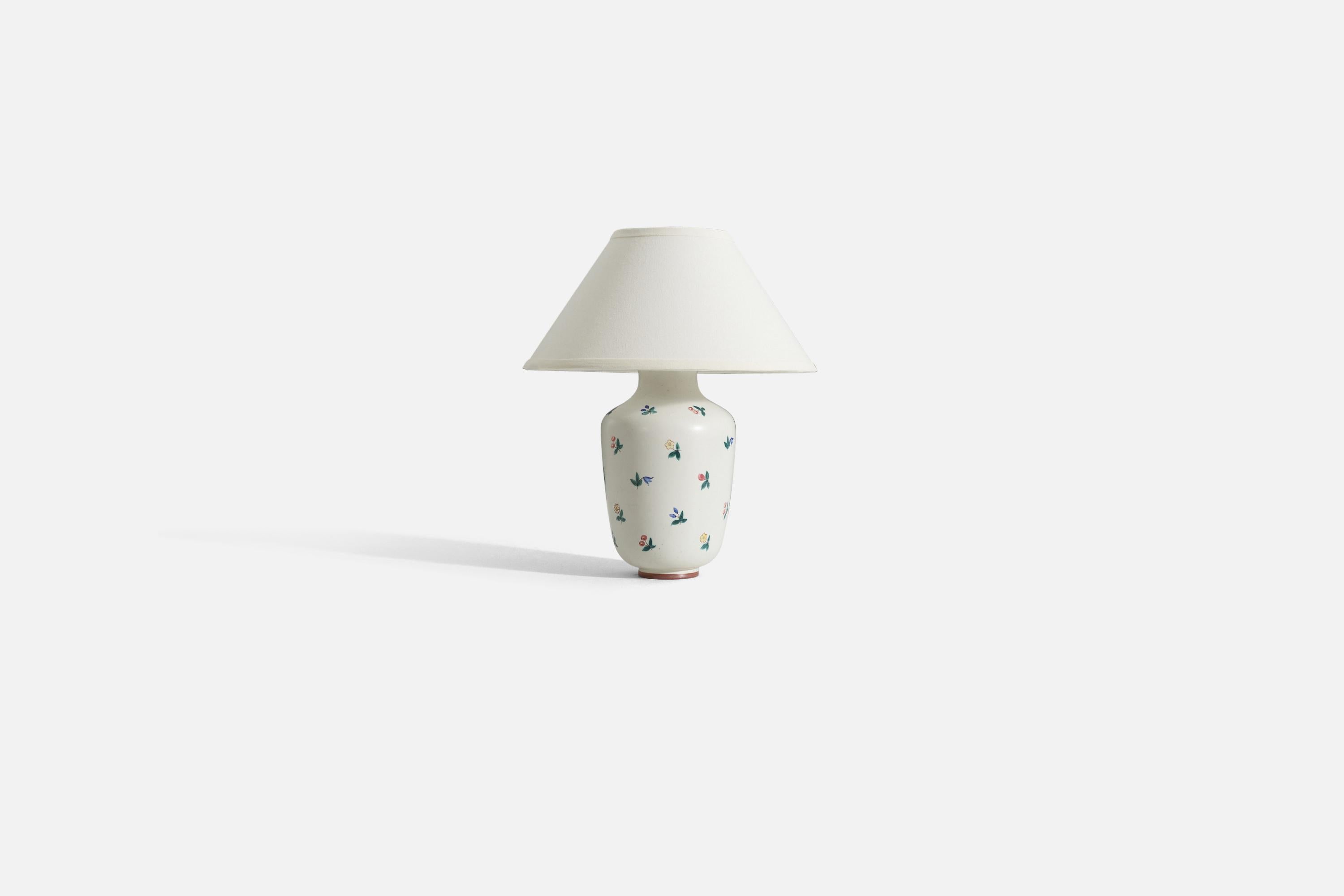 A white glazed table lamp with hand-painted floral decoration produced by Rörstrand. 

Sold without lampshade. 
Dimensions of Lamp (inches) : 14 x 6 x 6 (H x W x D)
Dimensions Shade (inches) : 5.75 x 14 x 8 (T x B x H)
Dimension of Lamp with