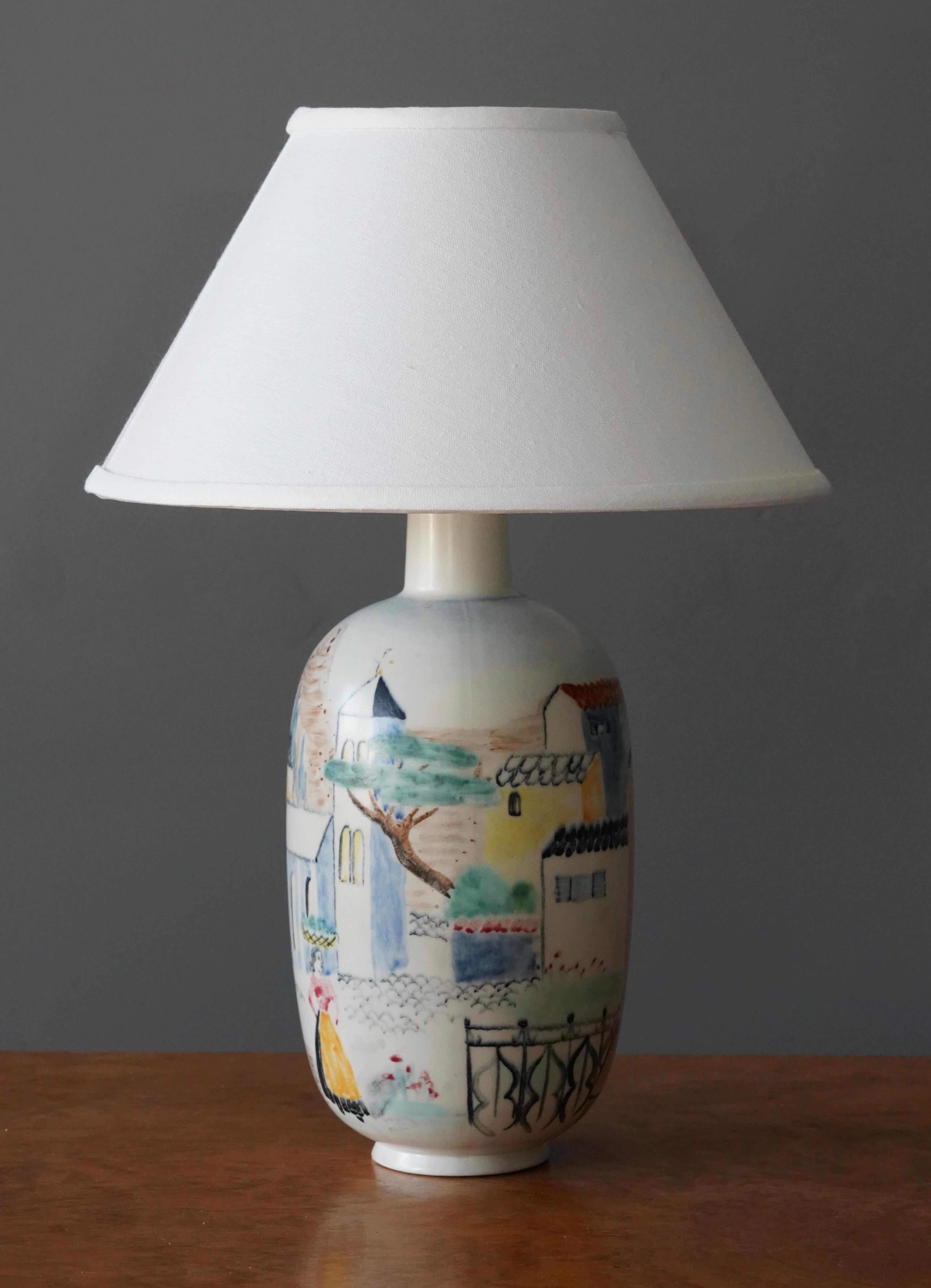 A table lamp produced by Rörstrand. Stamped. Hand-painted and glazed ceramic. With figurative motifs.

Dimensions listed are without shade. 
Dimensions with shade: Height is 17.5 inches, Width is 12.25 inches.
Dimensions of shade: Top diameter