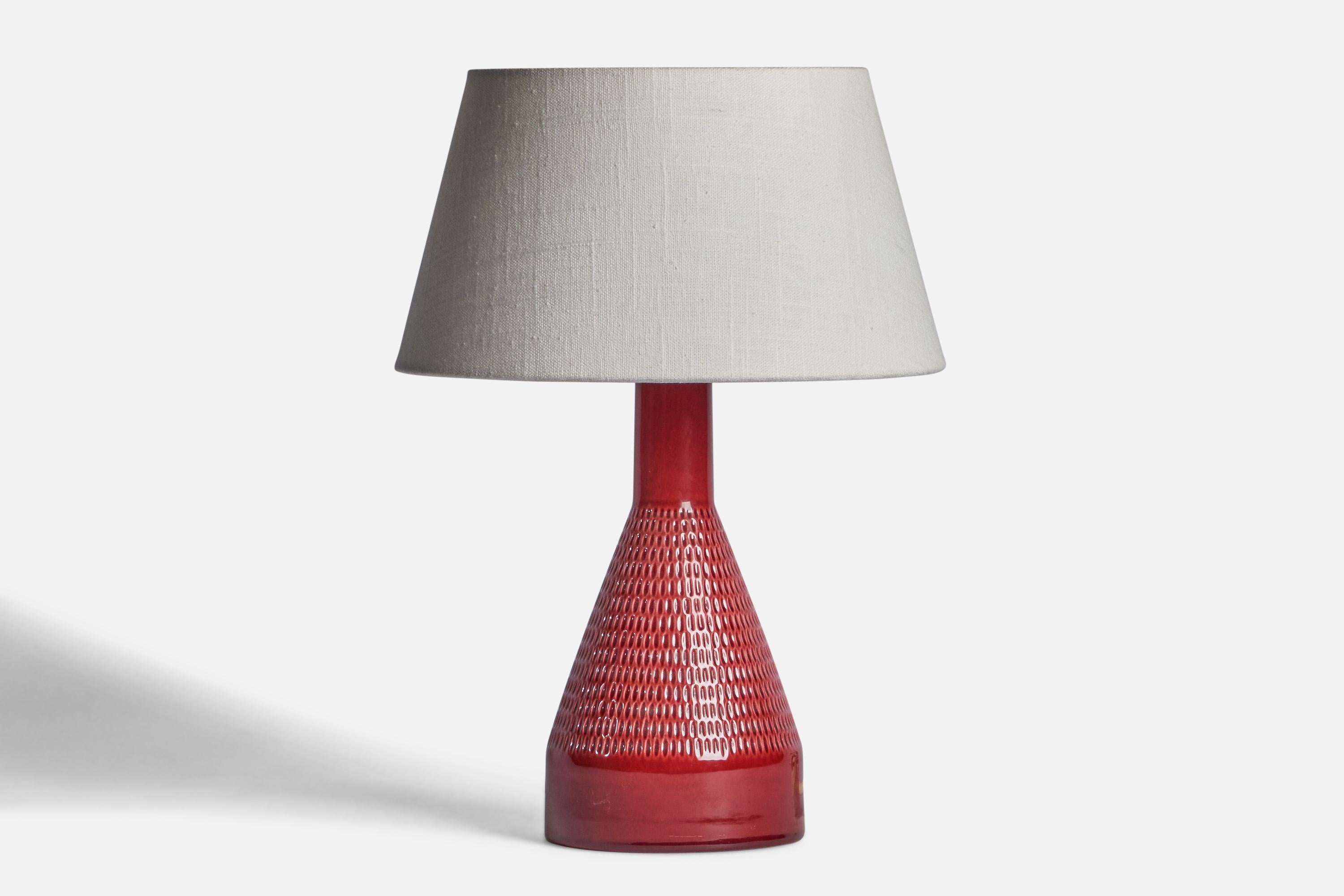 A red-glazed and incised stoneware table lamp produced by Rörstrand, Sweden, c. 1960s.

Dimensions of Lamp (inches): 11.25” H x 4.75” Diameter
Dimensions of Shade (inches): 7” Top Diameter x 10” Bottom Diameter x 5.5” H 
Dimensions of Lamp with
