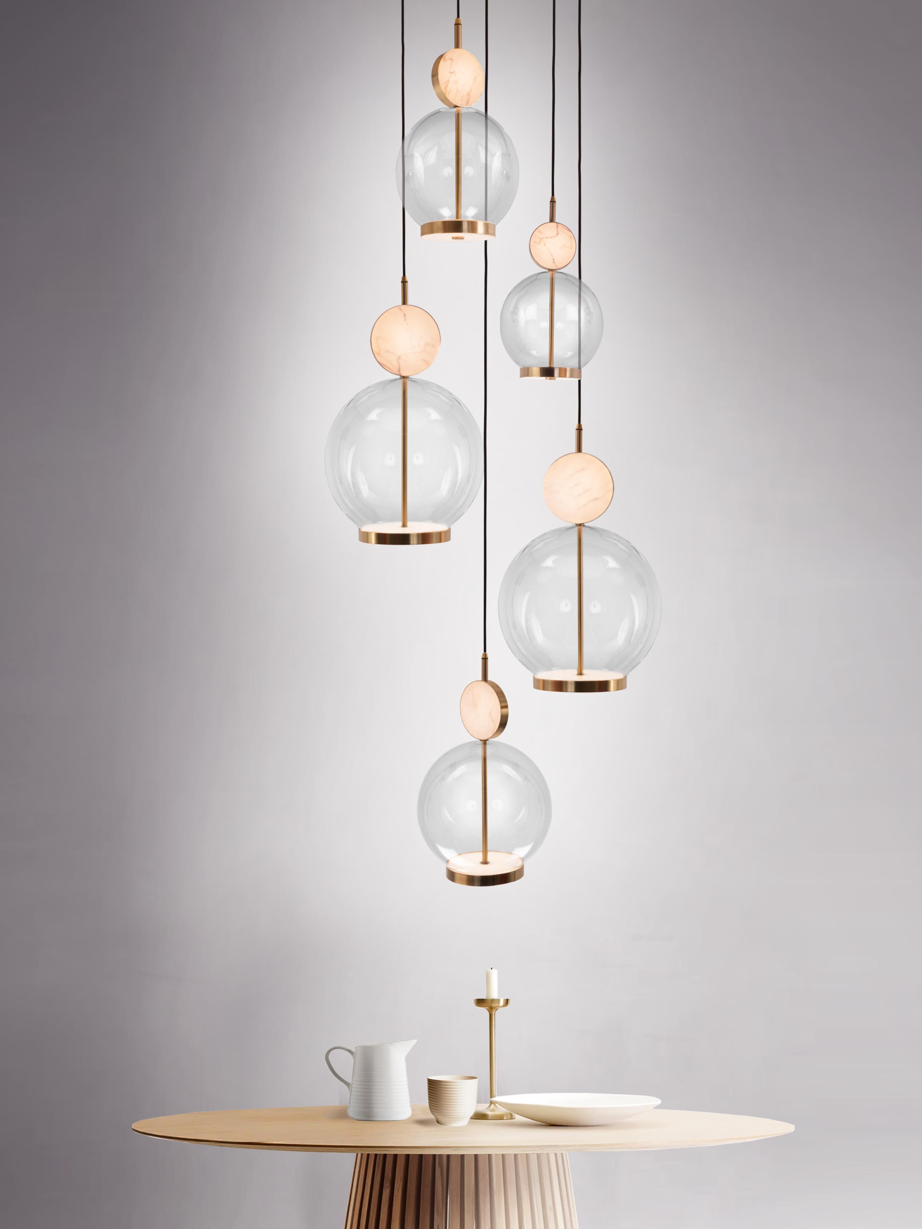 The Rosa collection was designed to showcase the opaque beauty of natural marble. The pendant incorporates a backlit Rosa Estremoz marble disc that emits a soft, warm illumination, pierced by the natural veining of the stone.

The double faced LED