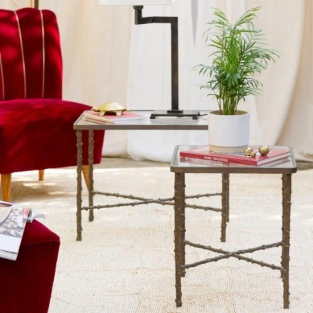 The Rosa Canina side table is a unique piece of furniture that combines classic brass with a touch of nature. It has a cast brass structure that recreates the characteristic stem of the Rosa Canina with its irregular surface studded with thorn. The