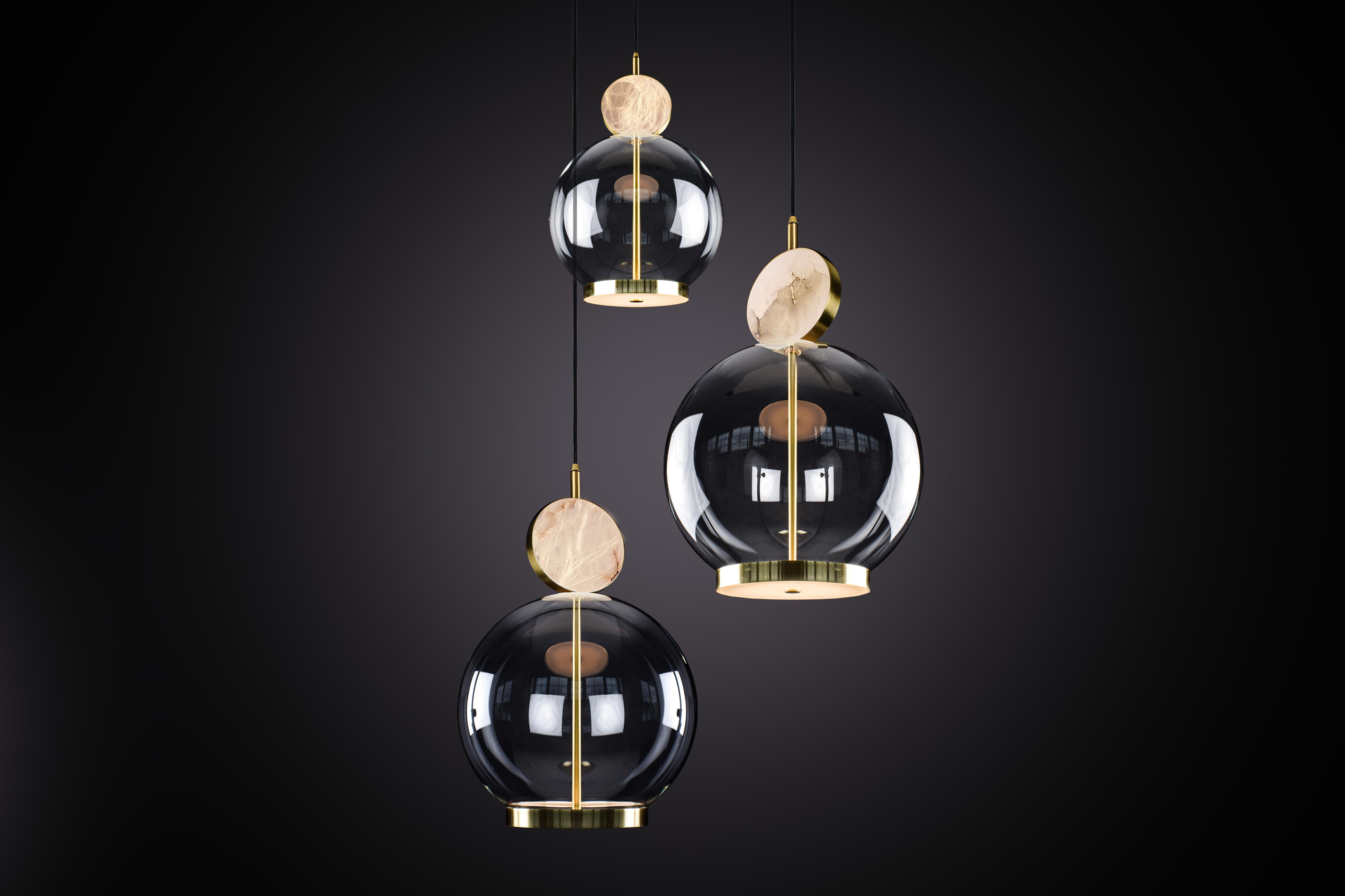 The Rosa collection was designed to showcase the opaque beauty of natural marble. The pendant incorporates a backlit Rosa Estremoz marble disc that emits a soft, warm illumination, pierced by the natural veining of the stone.

The double faced LED