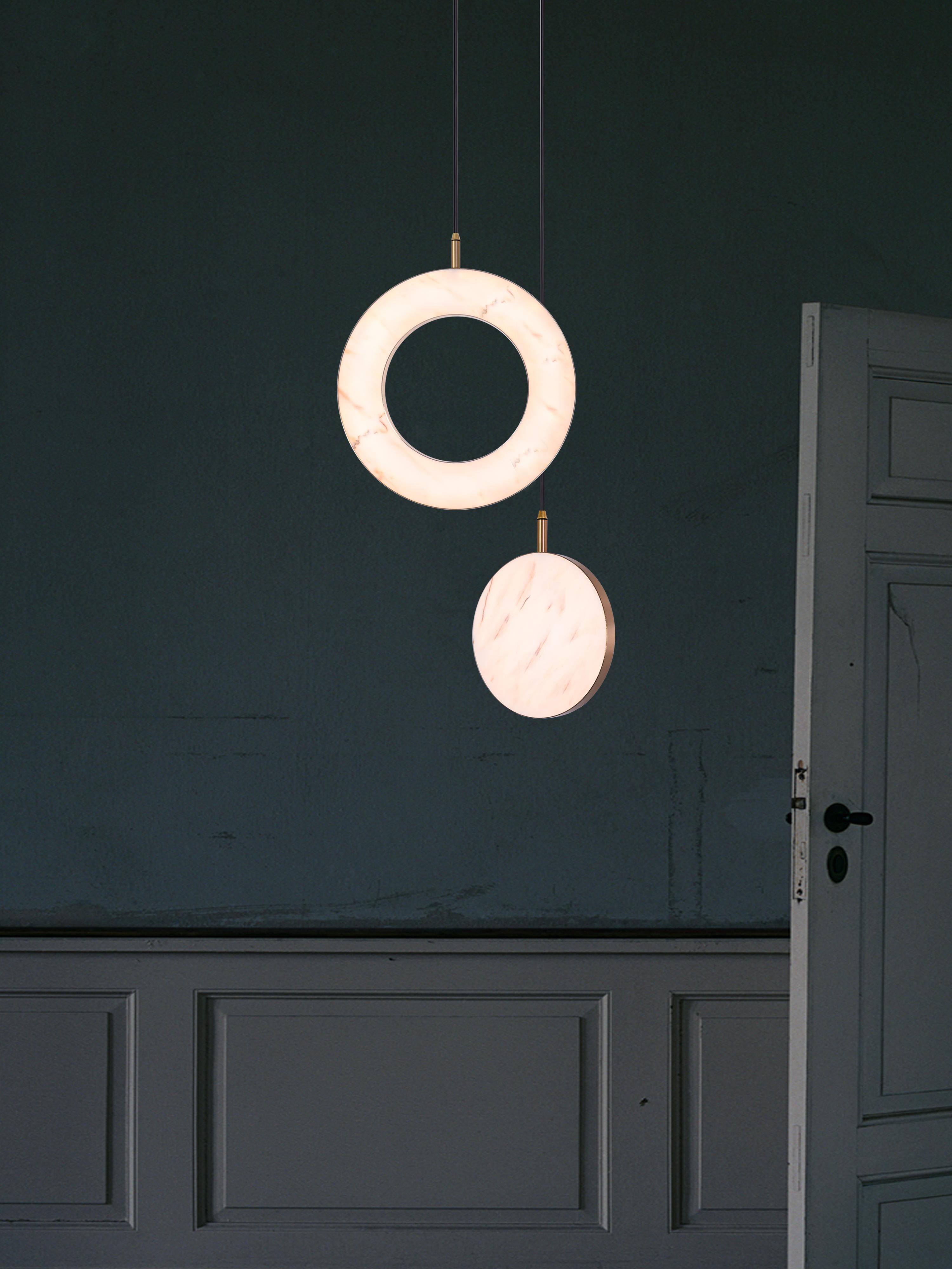 The Rosa Rings collection was designed to showcase the opaque beauty of natural marble. The pendant incorporates a backlit Rosa Estremoz marble disc that emits a soft, warm illumination, pierced by the natural veining of the stone.

Integrated