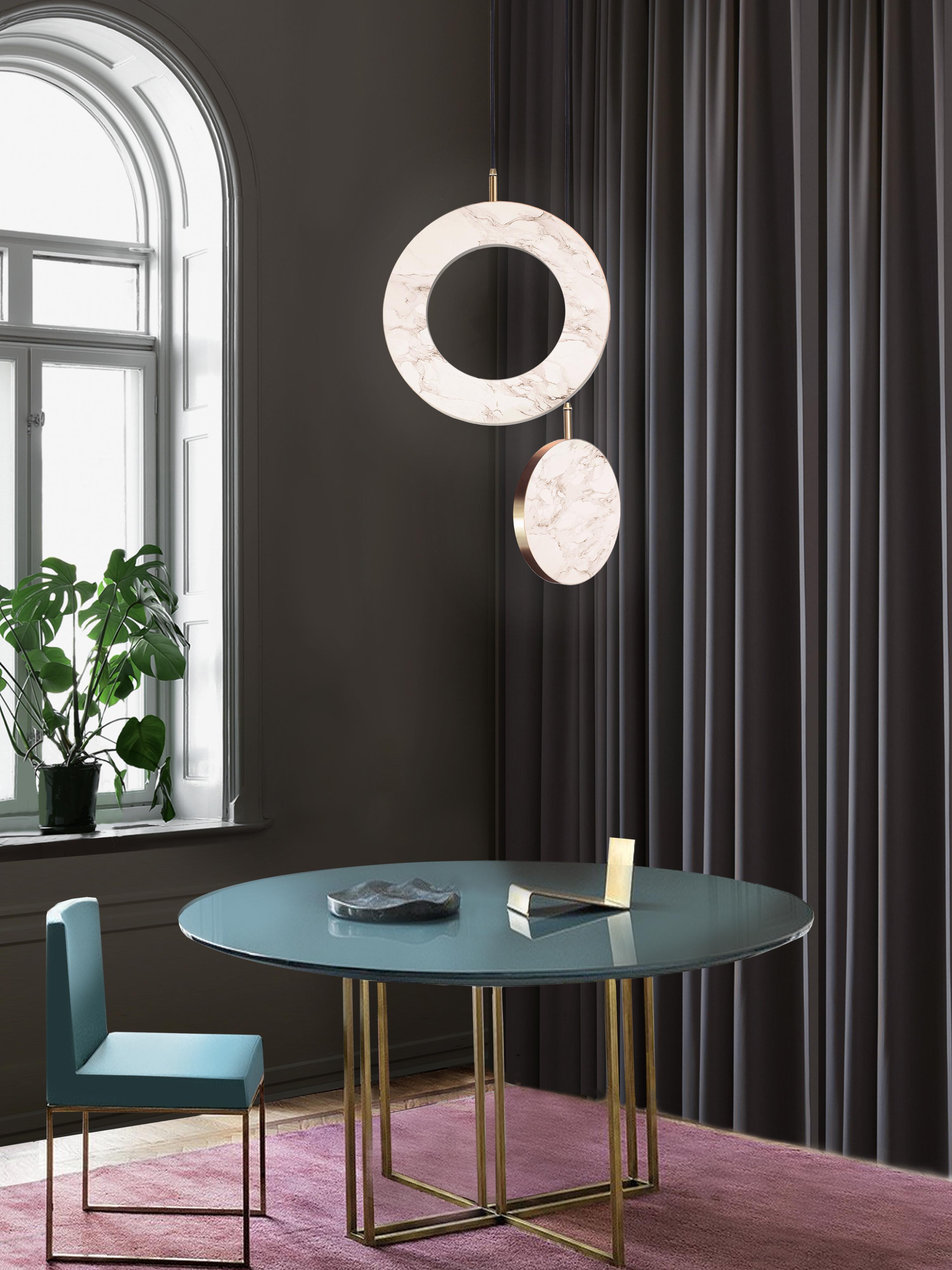 The Rosa Rings collection was designed to showcase the opaque beauty of natural marble. The pendant incorporates a backlit Rosa Estremoz marble disc that emits a soft, warm illumination, pierced by the natural veining of the stone.

Integrated