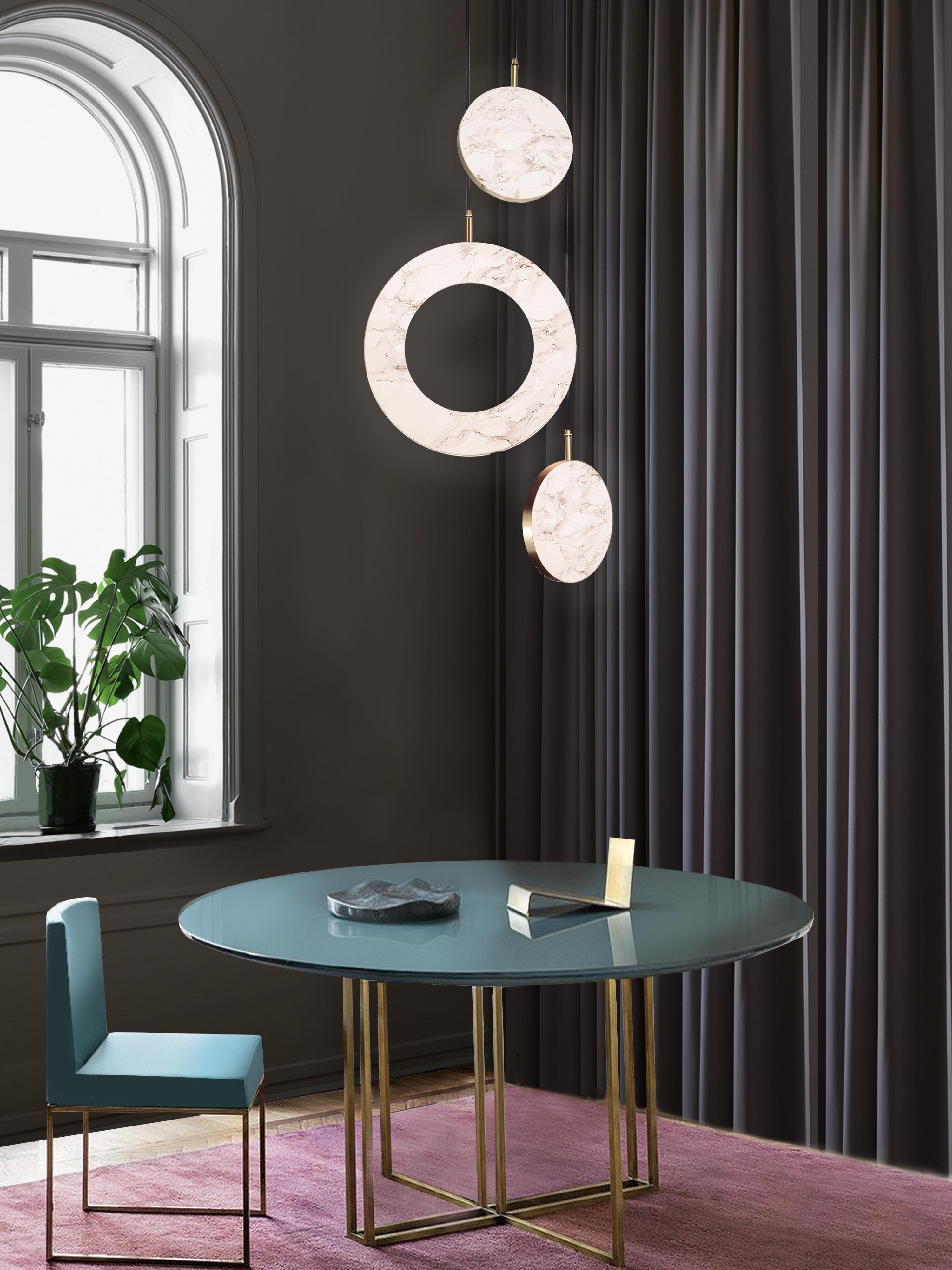 The Rosa Rings collection was designed to showcase the opaque beauty of natural marble. The pendant incorporates a backlit Rosa Estremoz marble disc that emits a soft, warm illumination, pierced by the natural veining of the stone.

Integrated