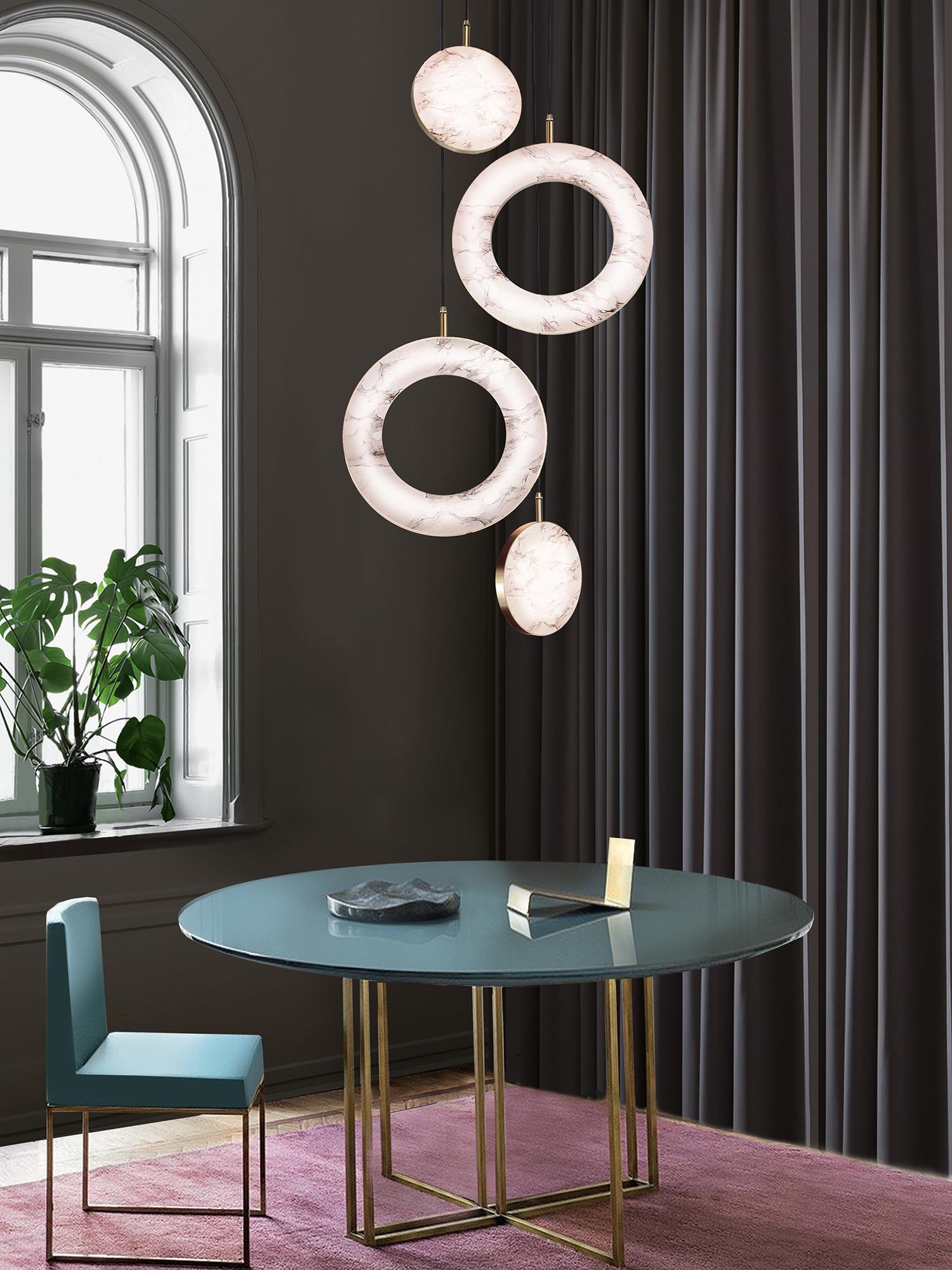 The Rosa Rings collection was designed to showcase the opaque beauty of natural marble. The pendant incorporates a backlit Rosa Estremoz marble disc that emits a soft, warm illumination, pierced by the natural veining of the stone.

Integrated