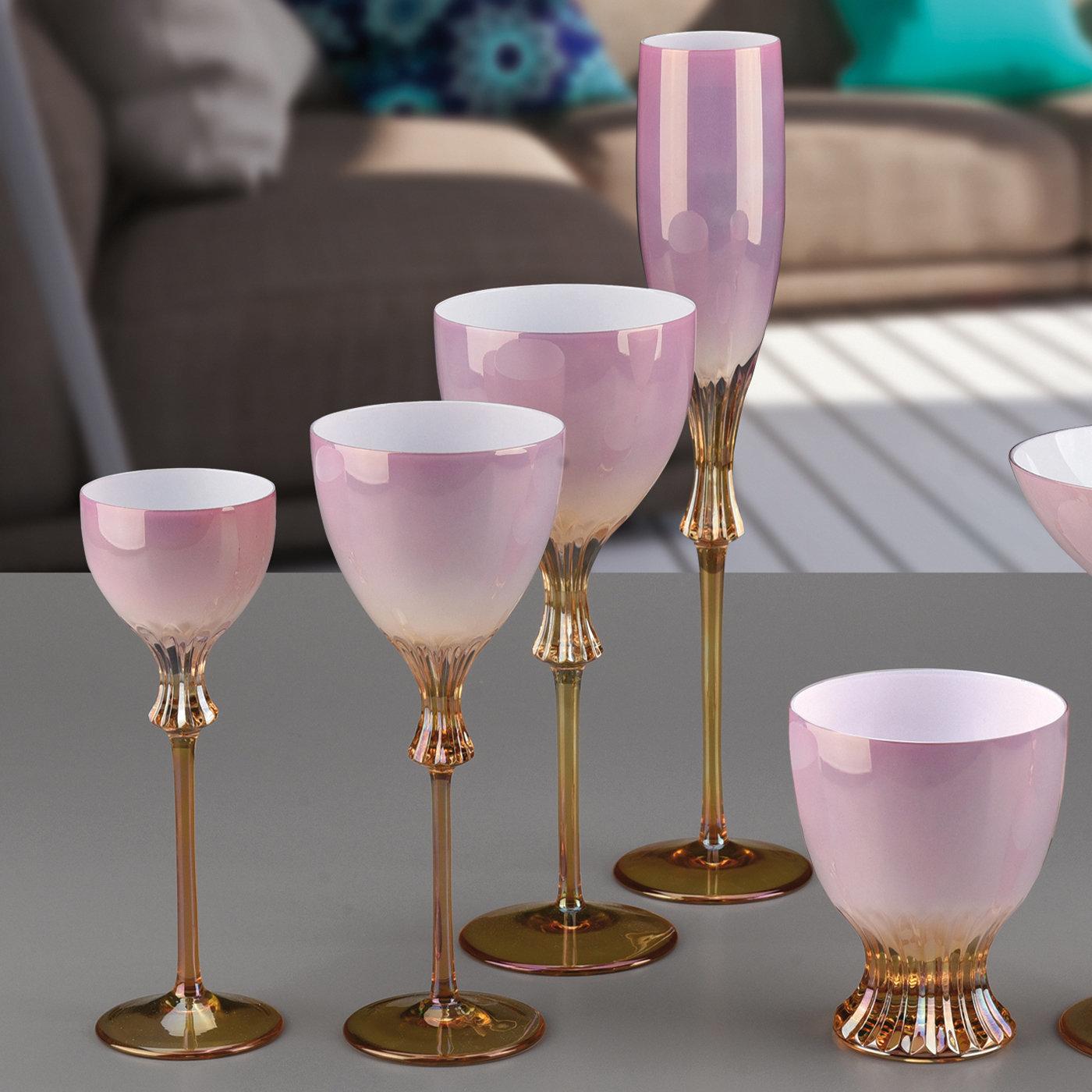 This sleek set features two water glasses, two wine glasses, and two flutes to add a lavish and graceful romantic accent to an elegant dining table. Showcasing mesmerizing pink hues fading to an amber-colored stem and base, each piece is deftly