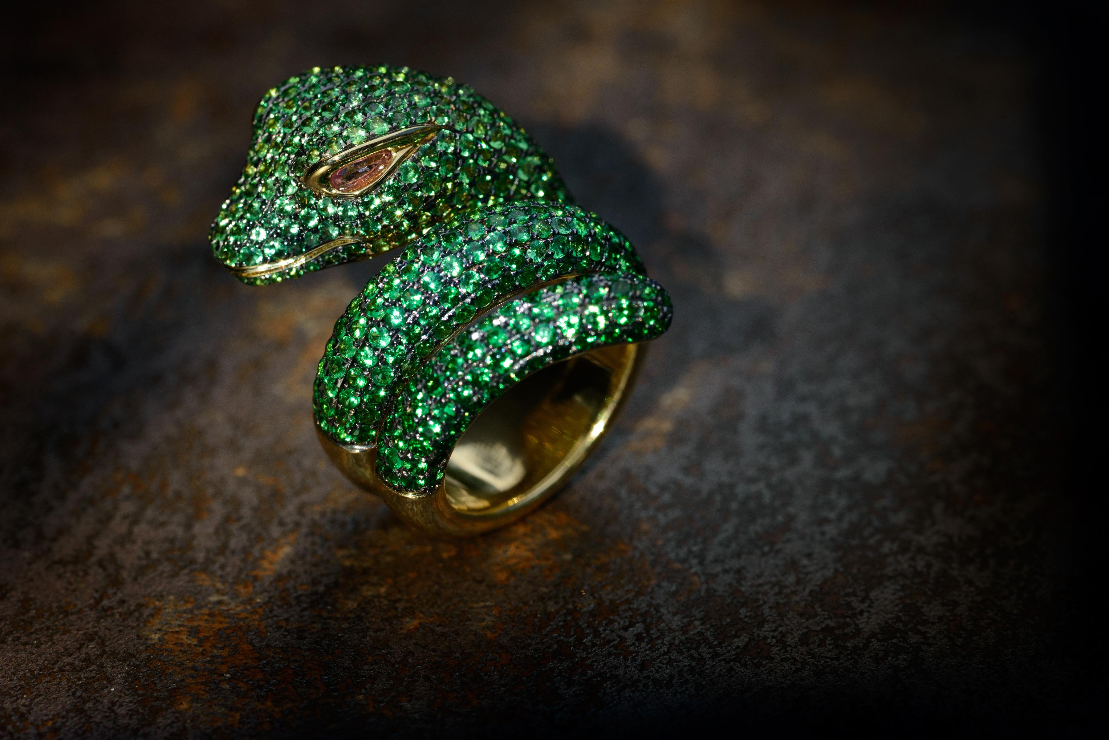 Anaconda snake shaped ring in 18 Karat yellow and black Gold with 6.46 Carat of Tsavorites on body and pear shaped cut 0.14 Carat pink Sapphire eyes.
None in stock available.
Lead time for any new orders is 8 weeks.
No returns for custom / made to