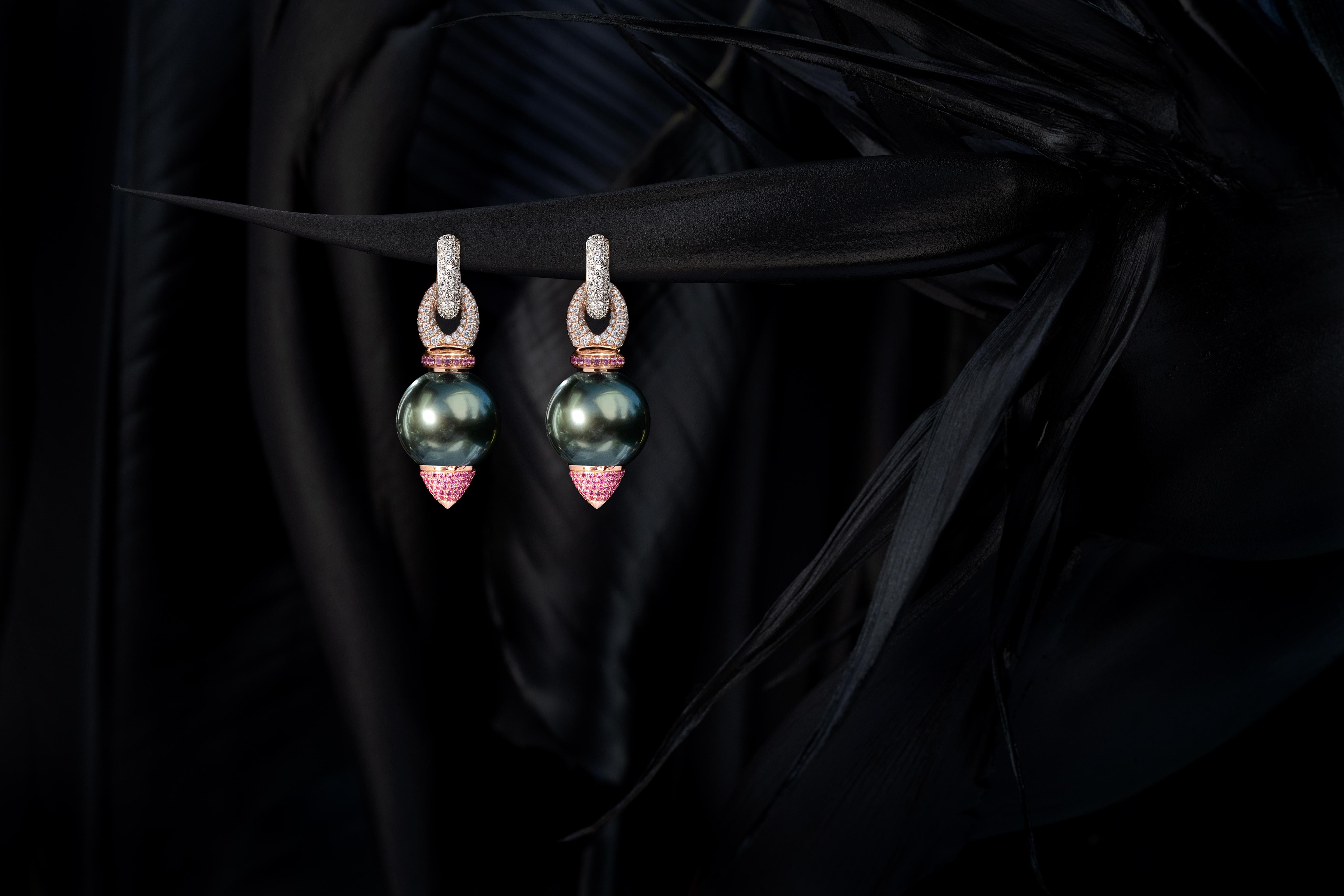 15mm peacock tone Tahitian Pearl (AAA quality) earrings with pink sapphires pavé cones in 18 Karat rose Gold and white Diamonds and pink Sapphires sliders. 
Shown on 18 Karat yellow Gold + white Diamond hoops.
None in stock available.
Lead time for
