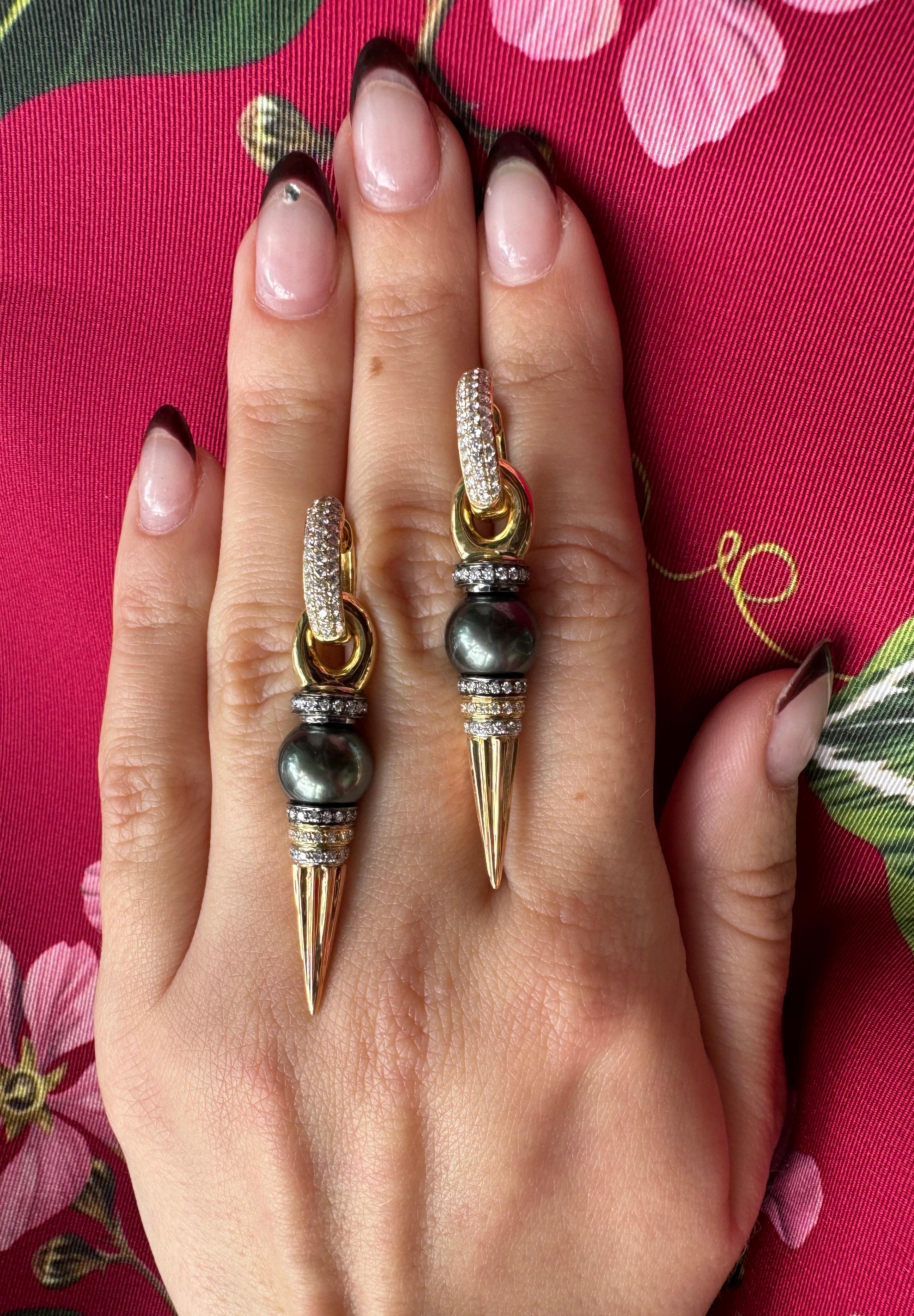 These bold and radiant dagger dangler earrings feature a Peacock-Tone Tahitian Pearl embellished with sparkling white diamonds set in 18K Yellow, Rose, White and Black Gold. Paired along with “Classic” Diamond hoops in 18K Yellow Gold for that extra