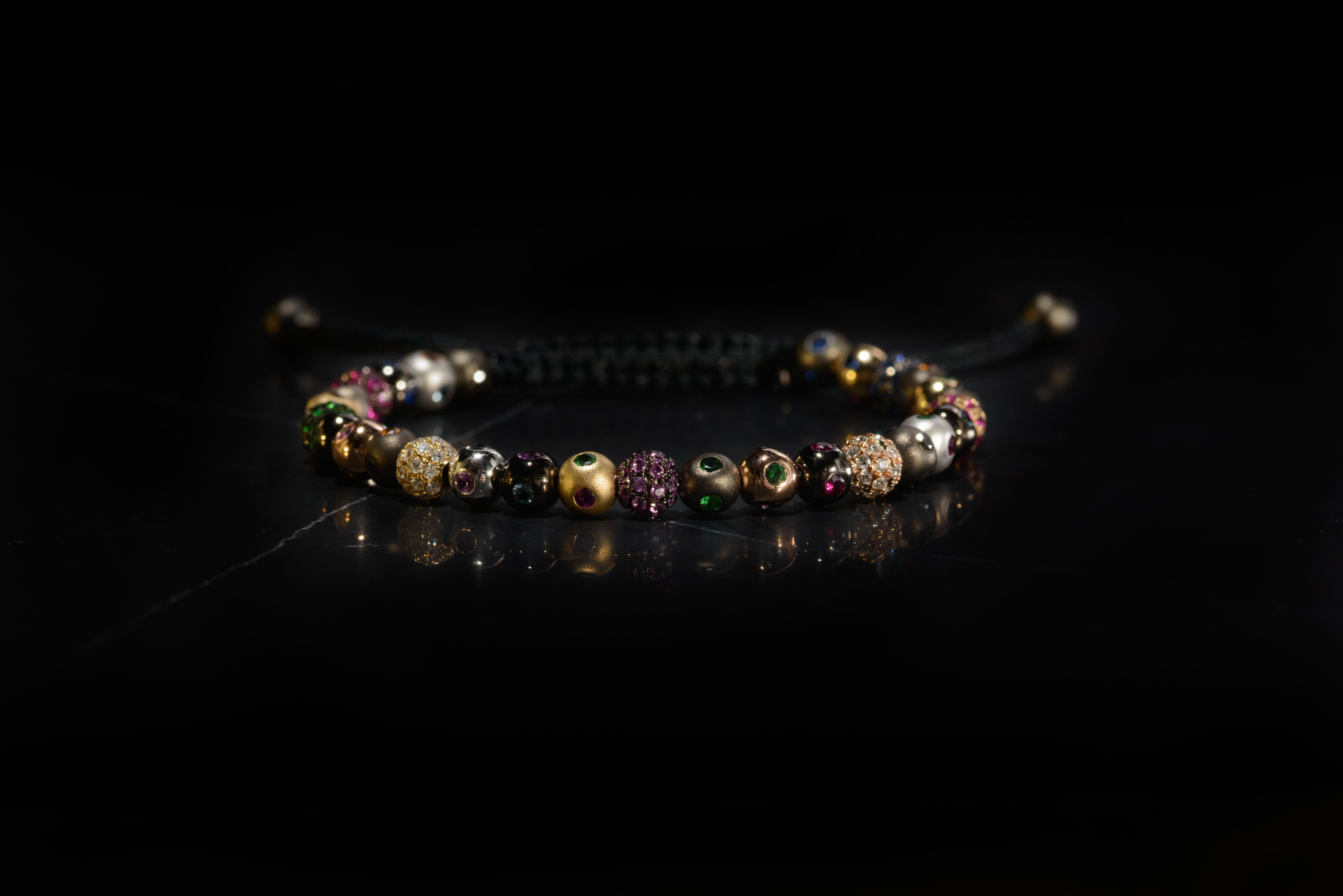 A bracelet made of a medley of twenty-eight 5mm pavé beads in 18 Karat yellow, white, black and rose Gold, with white Diamonds, Rubies, Tsavorites, blue, orange, yellow and pink Sapphires, in macramé (Ref. B.4)
Carat weight: White Diamond 0.50 CT /