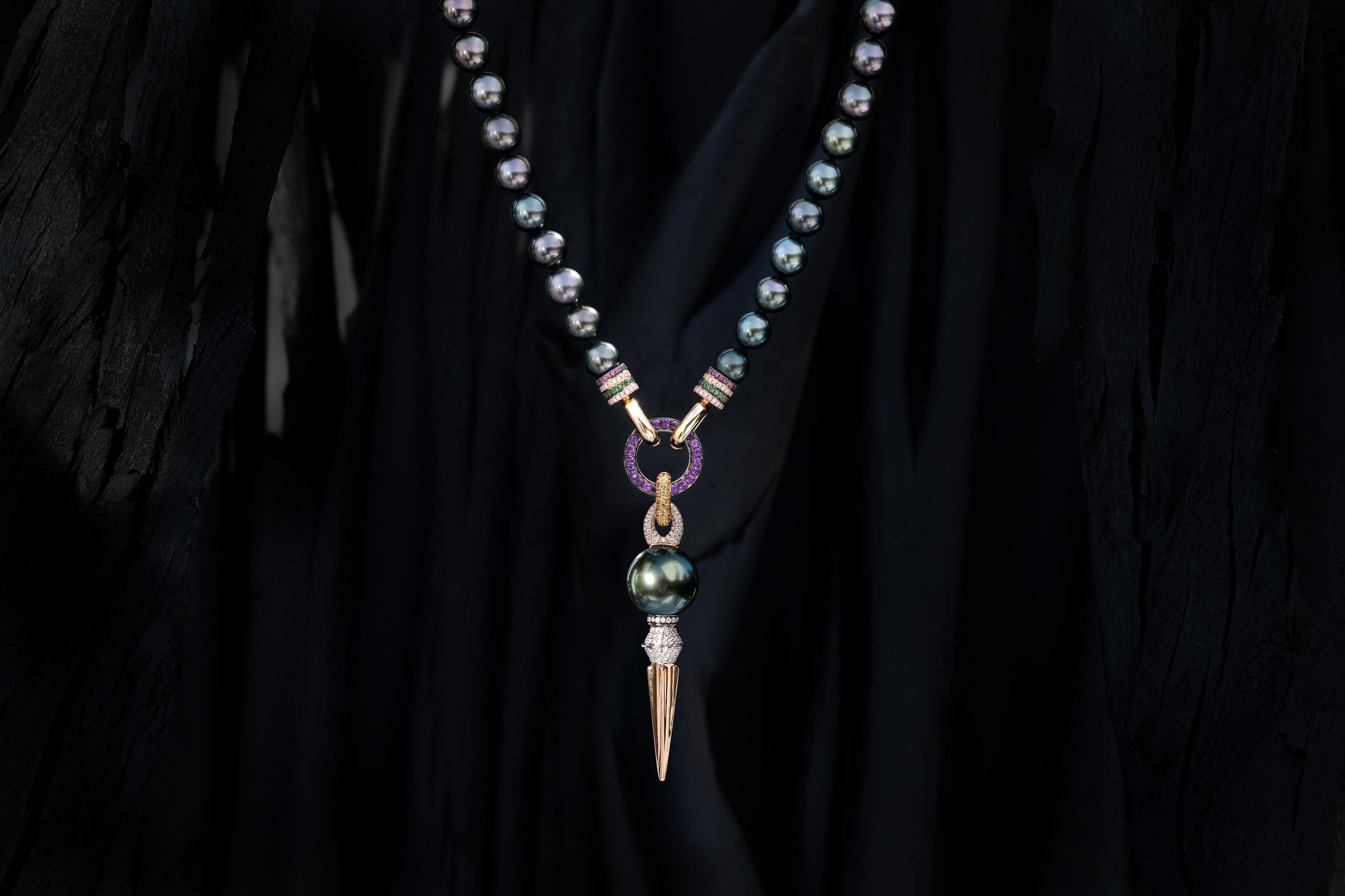 Rosa Van Parys signature 8MM Tahitian Pearl necklace (AAA quality) in 18 Karat yellow Gold + white Diamonds, Tsavorites and Rhodelites front clasp. Paired with a 18 karat black Gold + Amethysts add-on ring and a 18k yellow Gold + yellow Sapphires