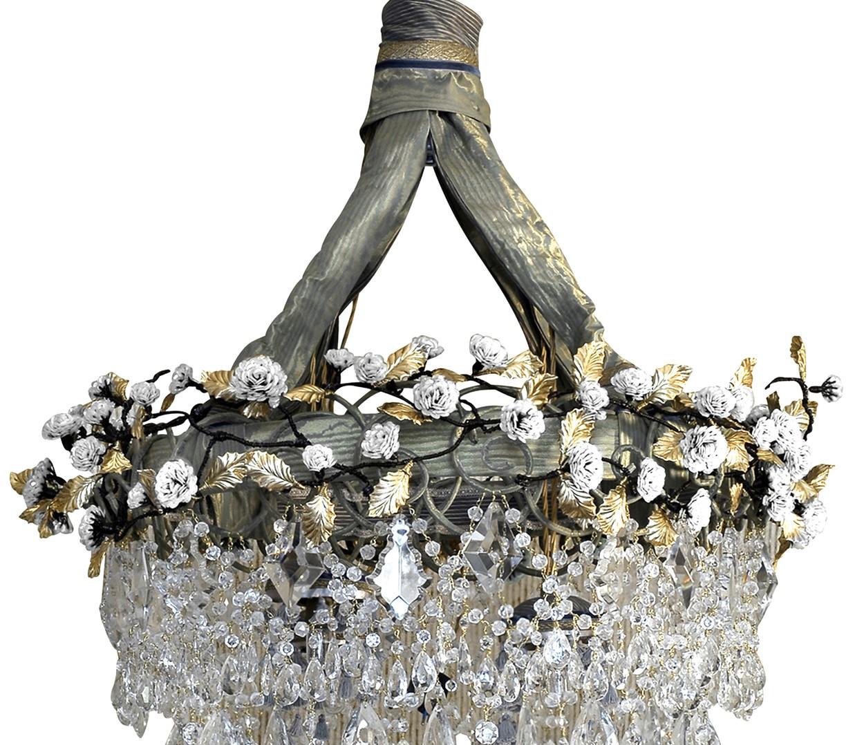 This magnificent chandelier combines the eclectic use of fabric, glass, crystals, brass and sequins to create a romantic effect. 3,000 sequins are attached with the use of 100 meters of wire to poetically evoke the branches of a delicate rose bush.