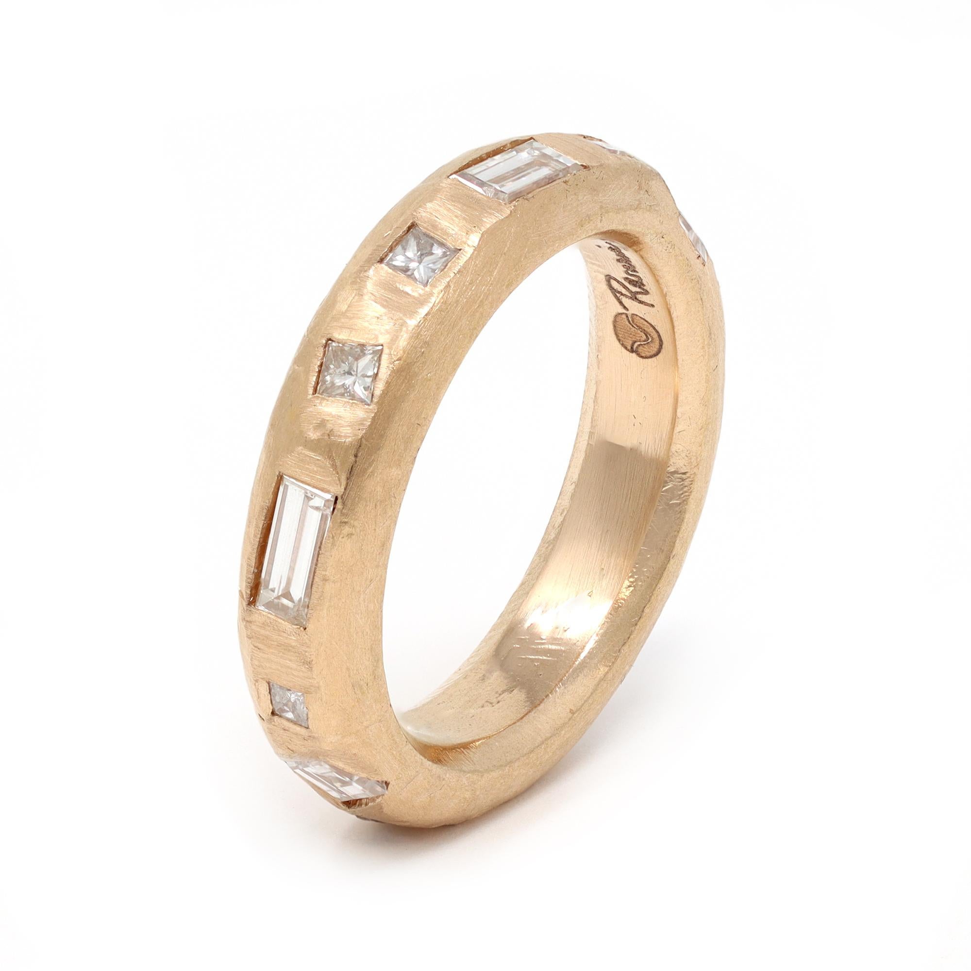 A 18 karat solid rose gold band ring created by Rosaria Varra. The band is studded with a mix of step cut diamonds. The weight of the diamonds is 1.36 carats, GH color and VS clarity. The gross weight is 9.6 grams and fits a size 6 ½.
 This band