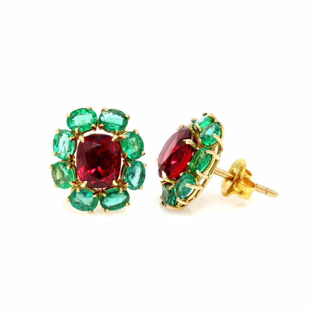 A pair of GIA No Heat Spinel and Emerald earrings in 18K yellow gold. Designed by Rosaria Varra, these vibrant earrings feature a central oval-cut Burmese natural untreated Spinel, weighing 2.06 and 1.92 carats, boasting a deep red color, and coming