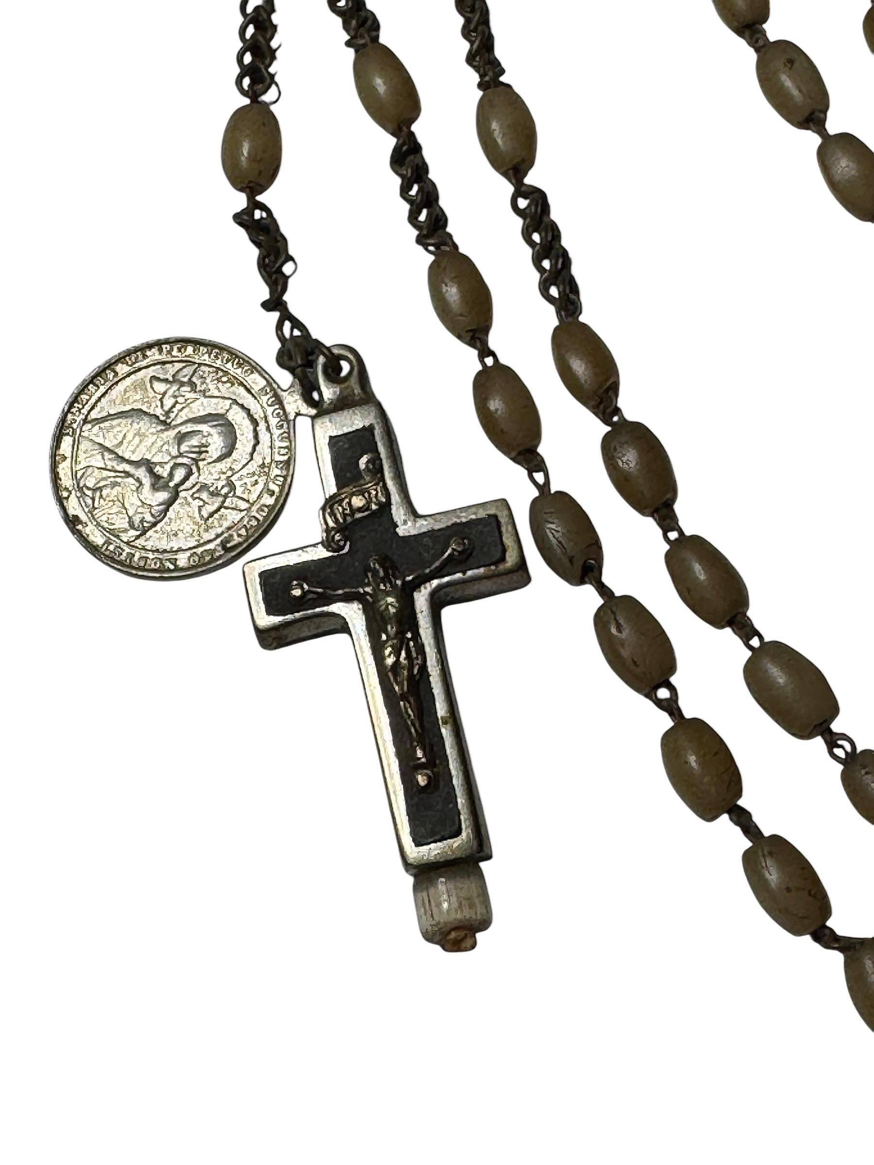 This vintage reliquary contains relics of a Saint. It is made of metal. It's 1 1/2