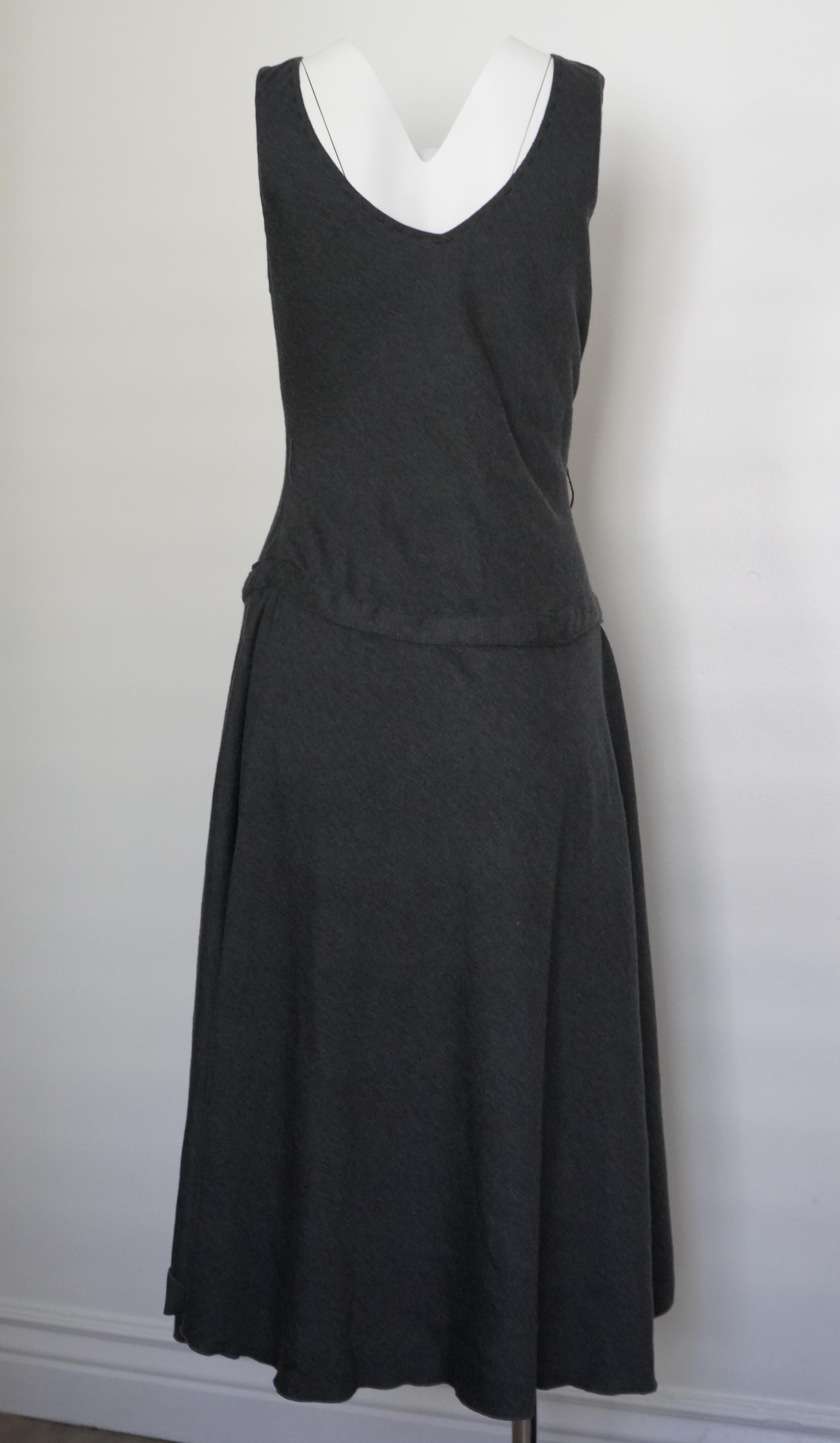 Stretch fabric
V-neck
Midi length
Ruching in the front 
Has belt loops, but no belt
Size 44
Total length 48 inches
