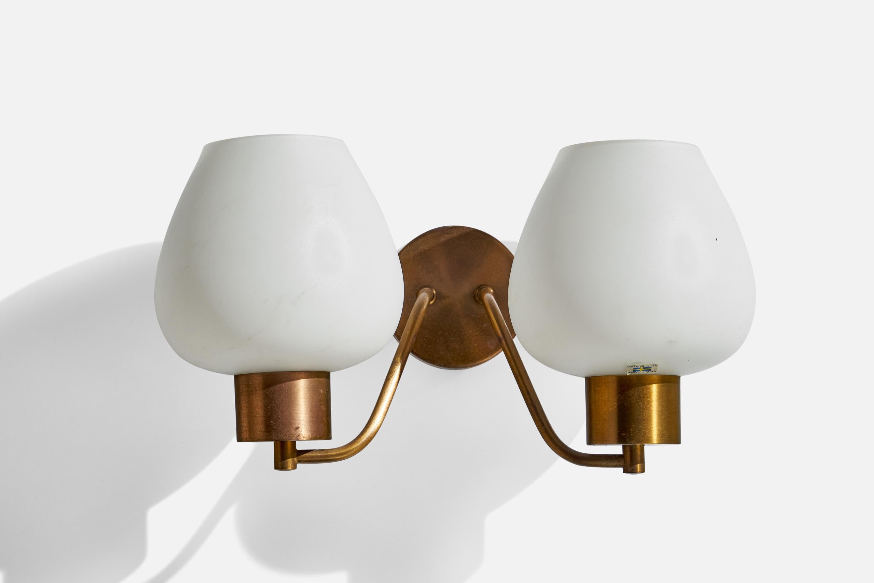 A pair of brass and opaline glass wall lights designed and produced Rosdala Glas, Sweden, c. 1970s.

Overall Dimensions (inches): 9”  H x 7.5” W 16” x 8.5” D
Back Plate Dimensions (inches): 4”  H x 4”  W x .75”  D
Bulb Specifications: E-26