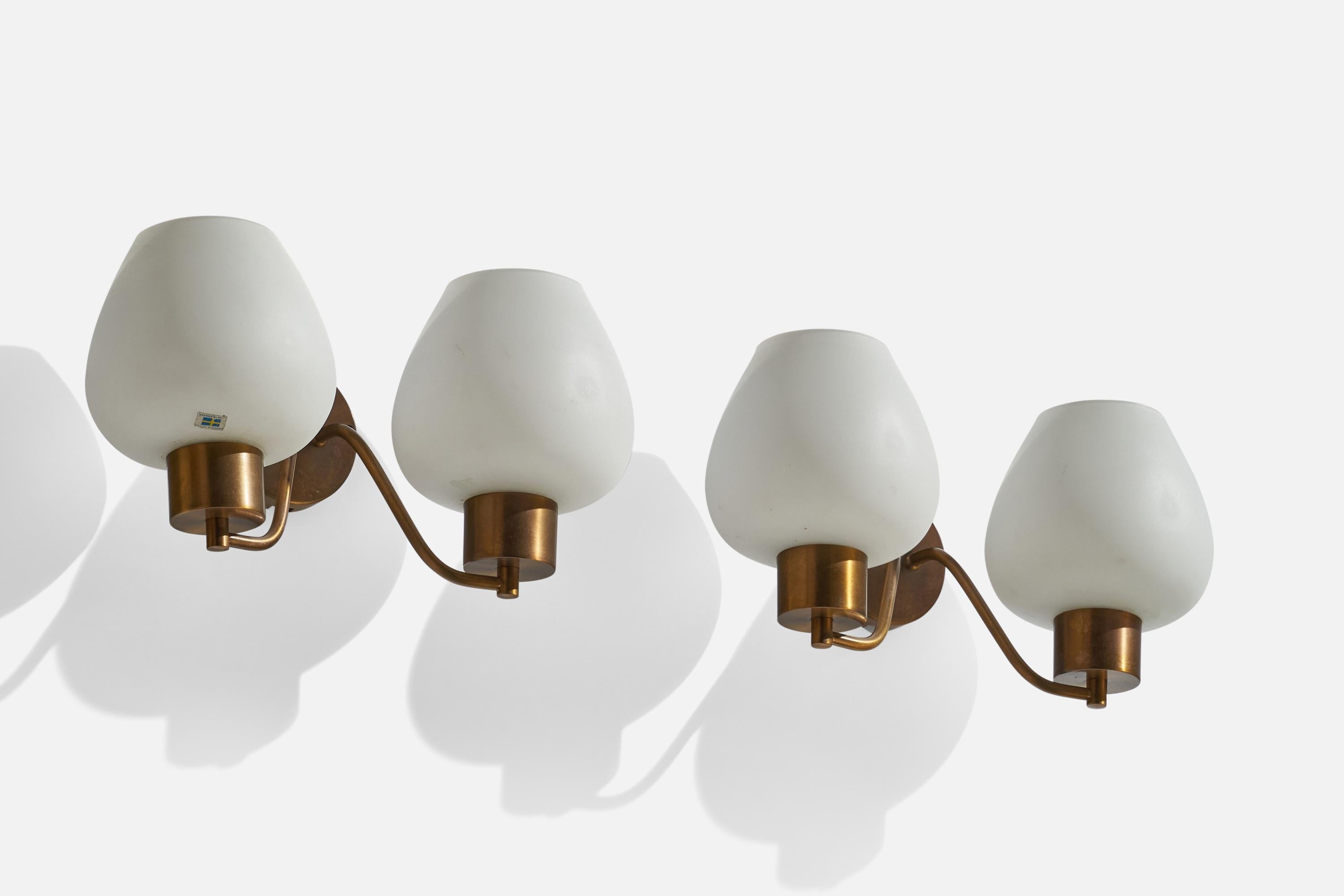 A pair of brass and opaline glass wall lights designed and produced Rosdala Glas, Sweden, c. 1970s.

Overall Dimensions (inches): 8.5”  H x 16”  W x 8” D
Back Plate Dimensions (inches): 4” H x 4”  W x .75” D
Bulb Specifications: E-26 Bulb
Number of