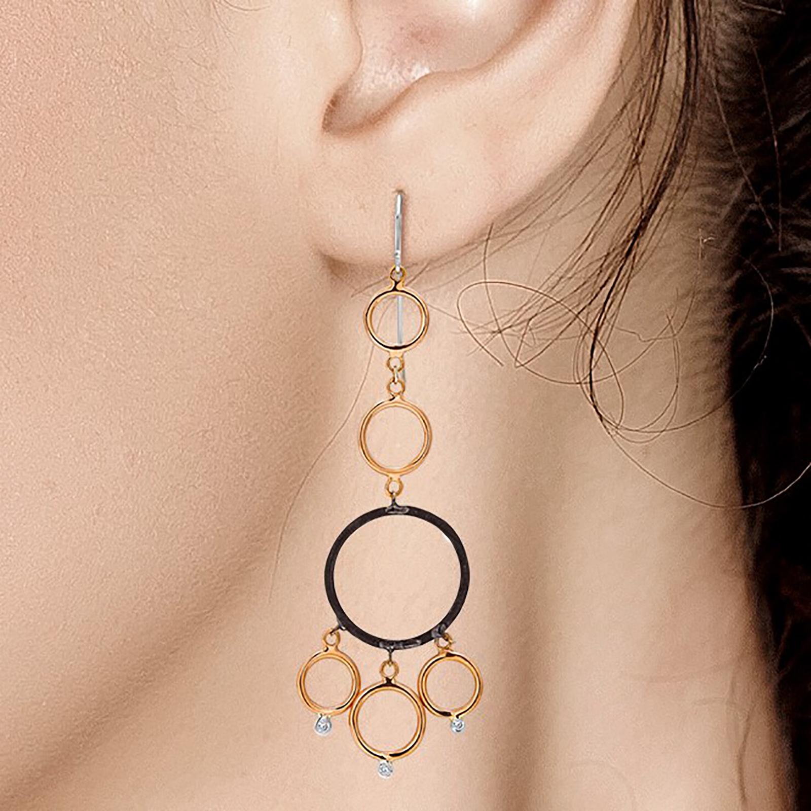 Fourteen karats rose and white gold circles with bezel-set diamonds 
Three-inch long earrings
Two Blacken silver circles  
Diamond weight 0.18 carats
14 karat gold large hoops.
New Earrings
The latest and innovative fashion collections have been