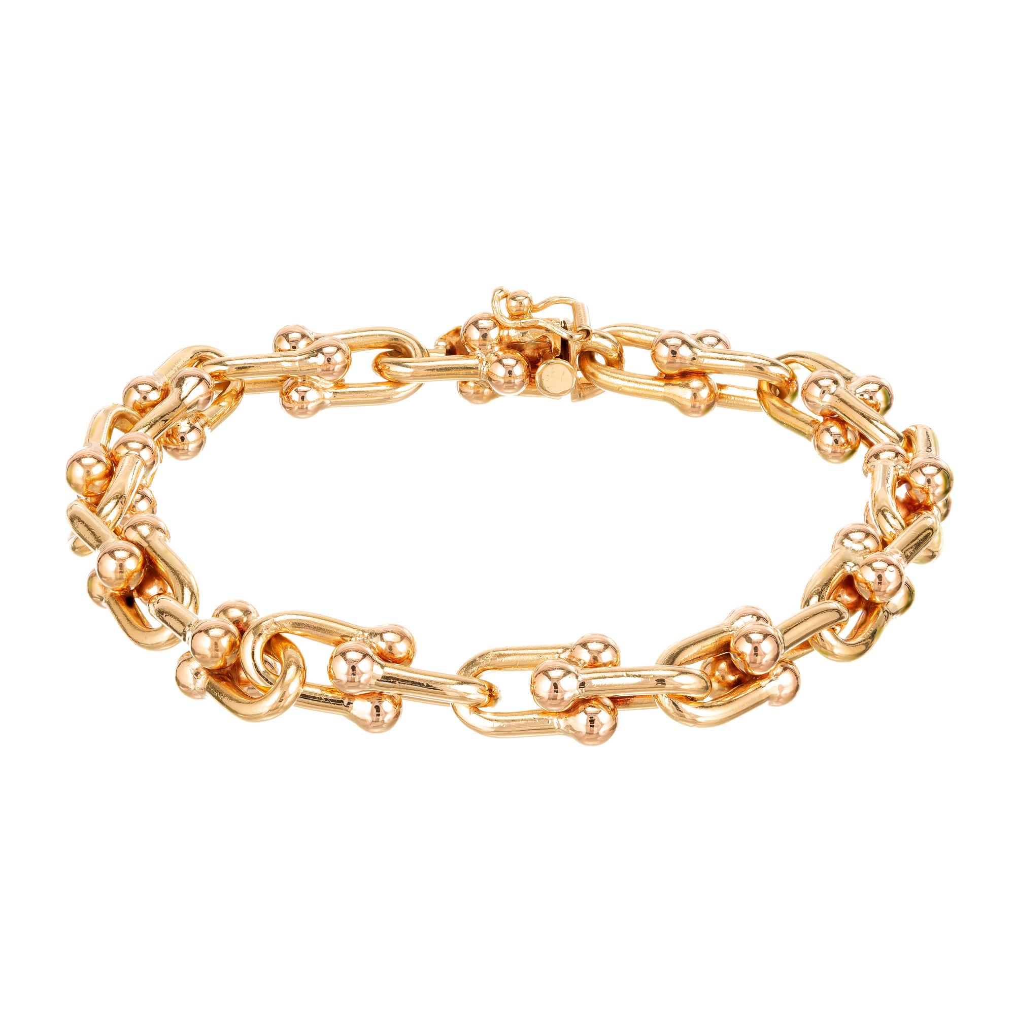 Vintage 1940-1950 solid 18k Rose Gold and Yellow Gold stirrup link Italian bracelet with hidden box catch 

Width: 7.93mm or .31 Inches
Bracelet/ Chain: 6.75 Inches
Depth or Thickness: 7.93mm
37.1 grams 
18k Yellow Gold 
18k Rose Gold
Stamped: