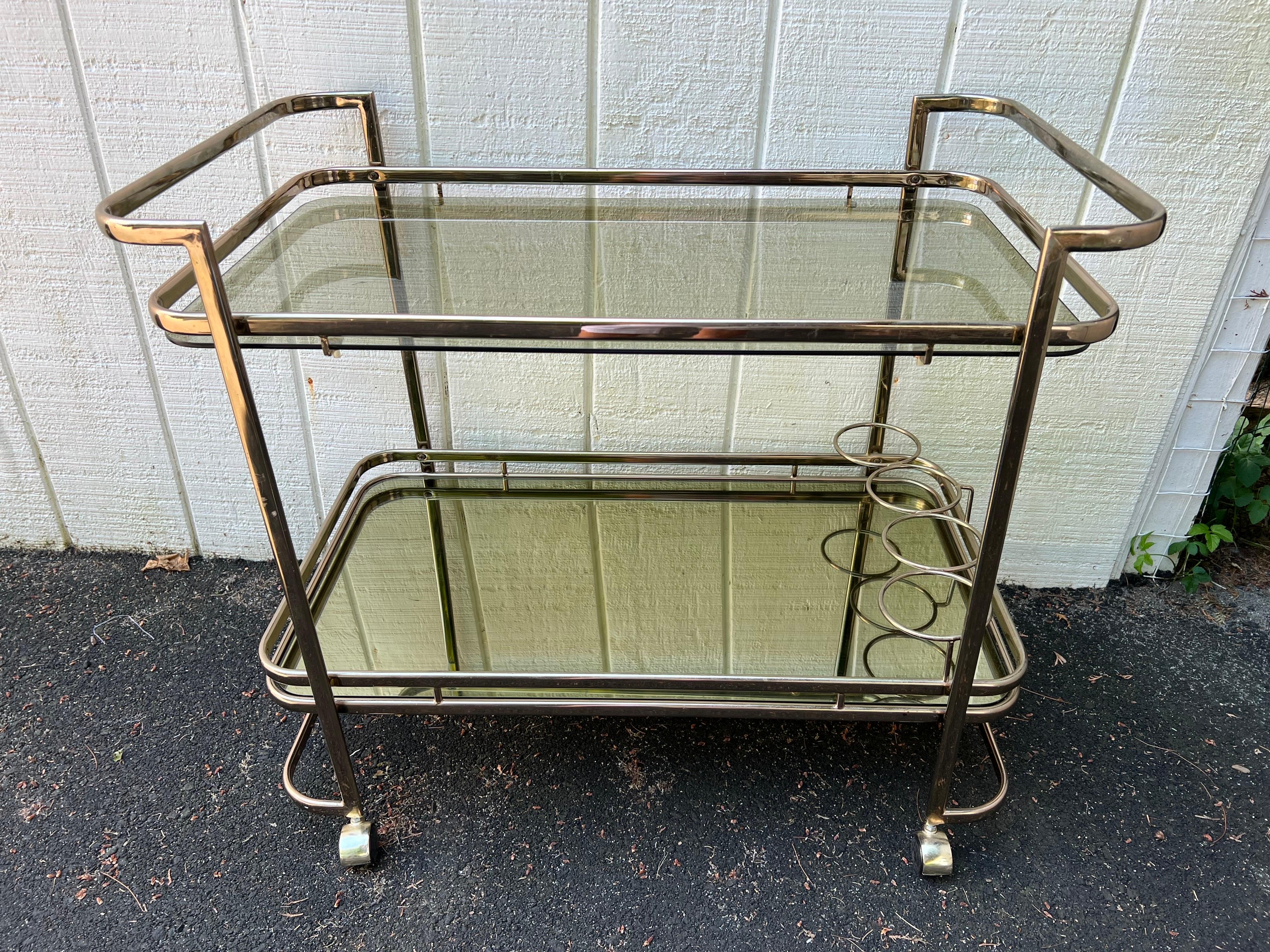 Rose Brass Smoked Glass an Mirror Bar Cart. Classic piece of furniture for the entertainer in you . Holds the liquor  bottles on the bottom shelf and pour into the glasses on top. wheel into whatever room you need it. 