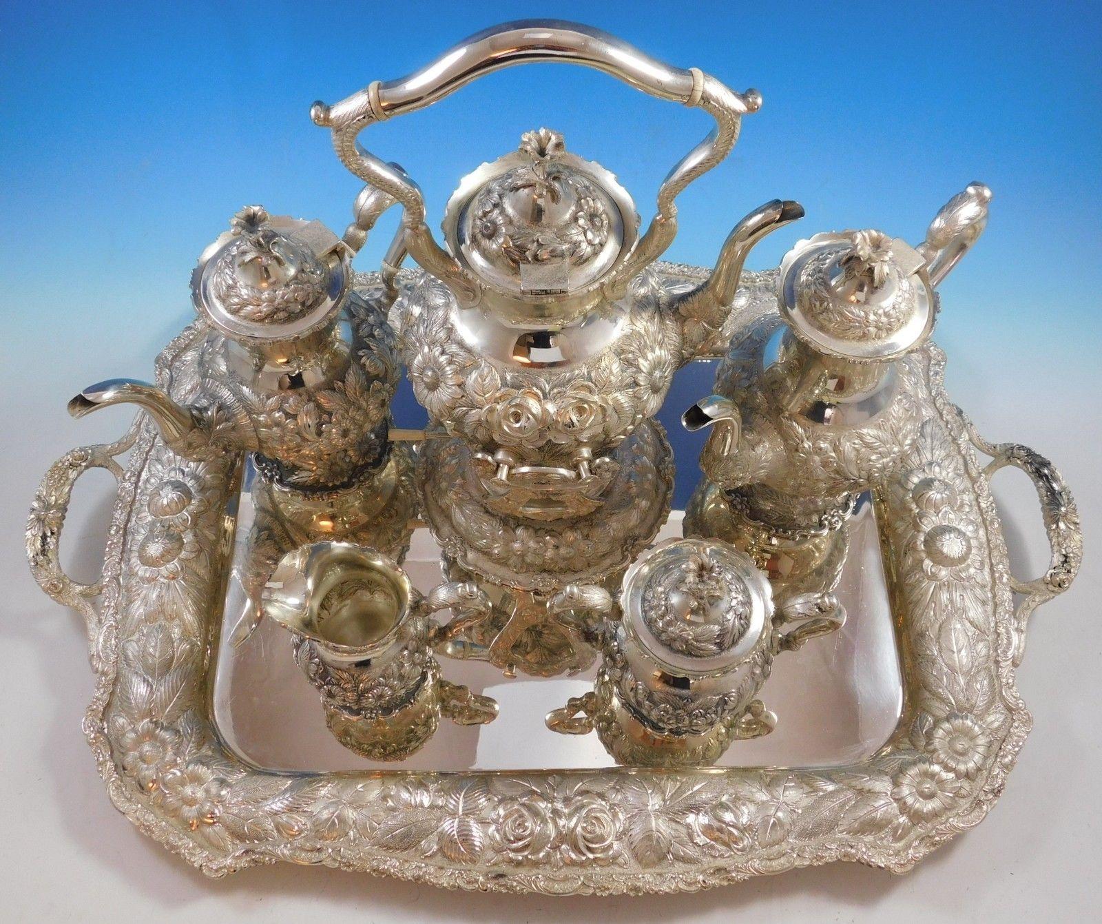 Rose by Stieff

Incredible rose by Stieff repoussed sterling silver five-piece tea set with sterling silver tray. This set features a 3-D flower finial and fine hand chased design. Stieff made many different rose tea sets, this is the largest that