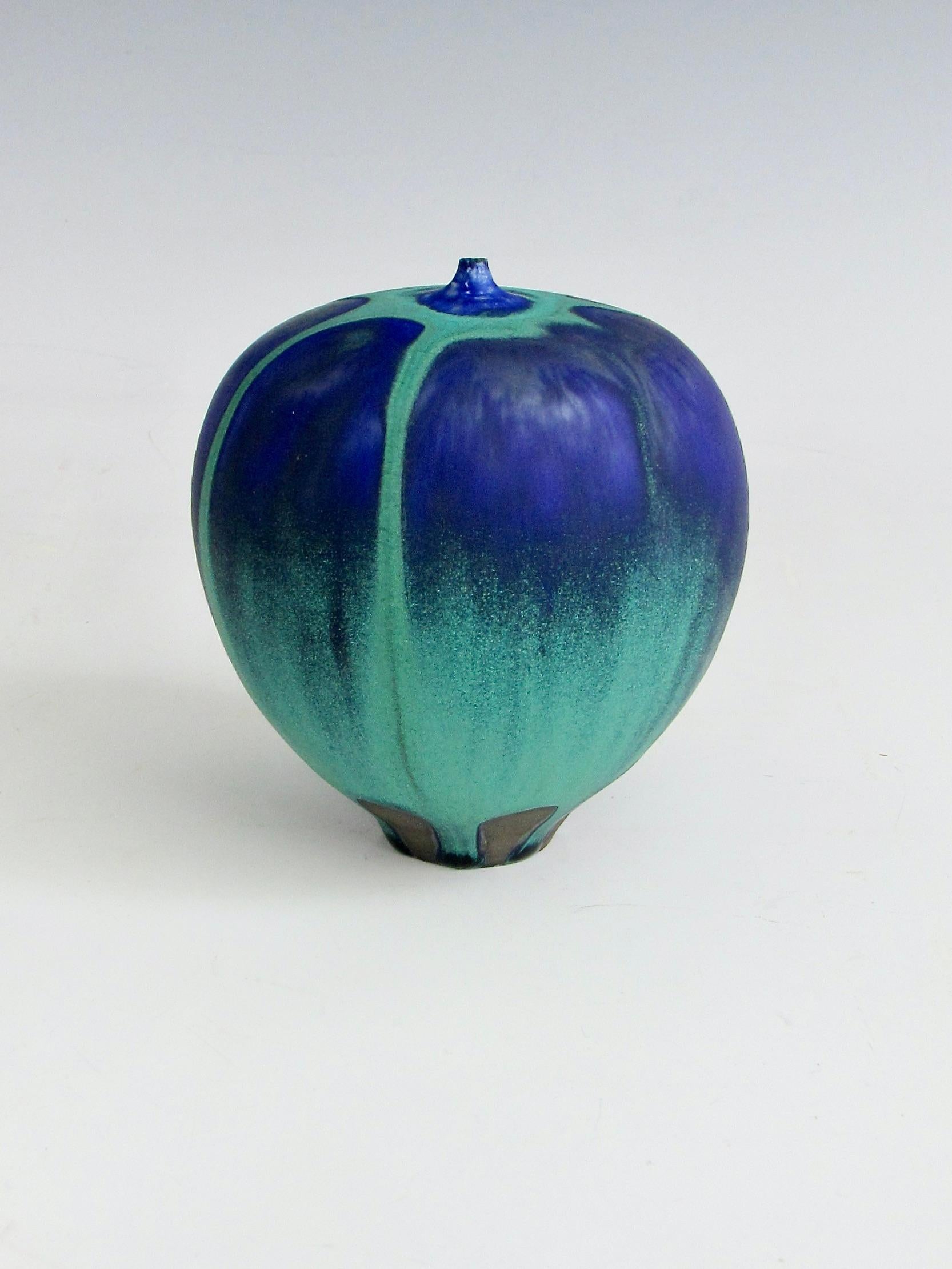 Feelie vase signed Cabat on underside . Seafoam or ocean green satin matte glaze over deep blue maybe indigo glaze also matte finish . Glazing of the green over blue brings to mind a hot air balloon . 
 Rose Cabat (1914-2015) was an American studio