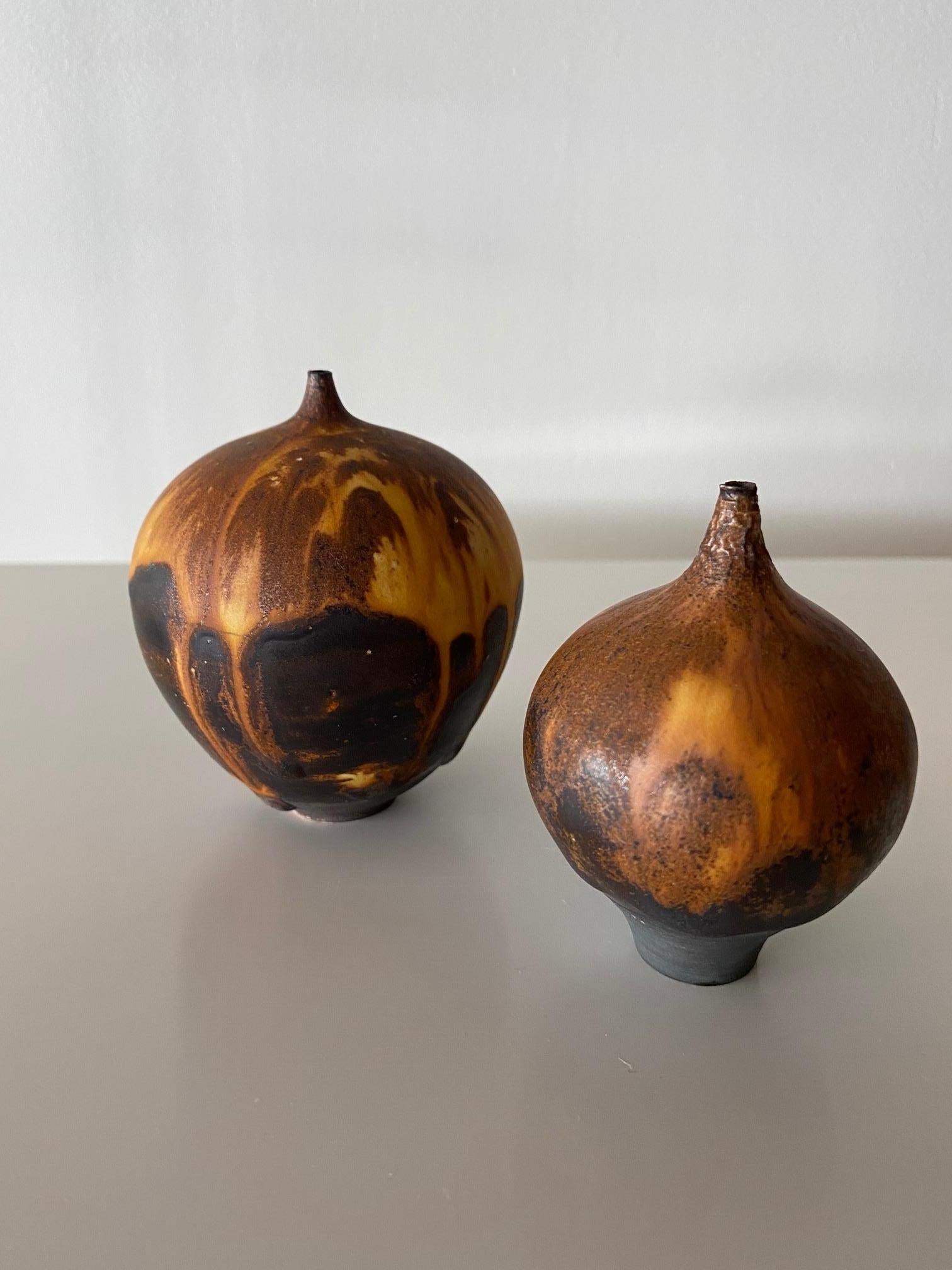 Beautiful pair of dark onion glaze 'Feelie' vases by Rose Cabat. Each piece is signed and larger example measures 3.5