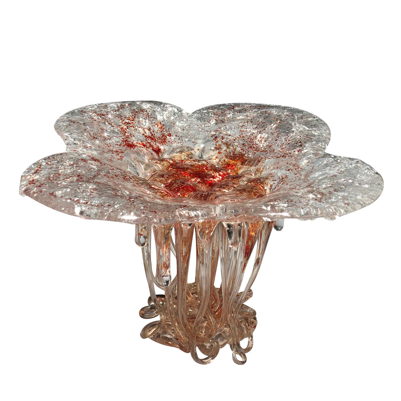 This unique and striking Murano glass sculpture in tones of pinks, reds and gold is a piece that is reminiscent of a sea creature or jellyfish with its flowing, flower-shaped top and dripping tentacles underneath. This gorgeous piece will be sure to