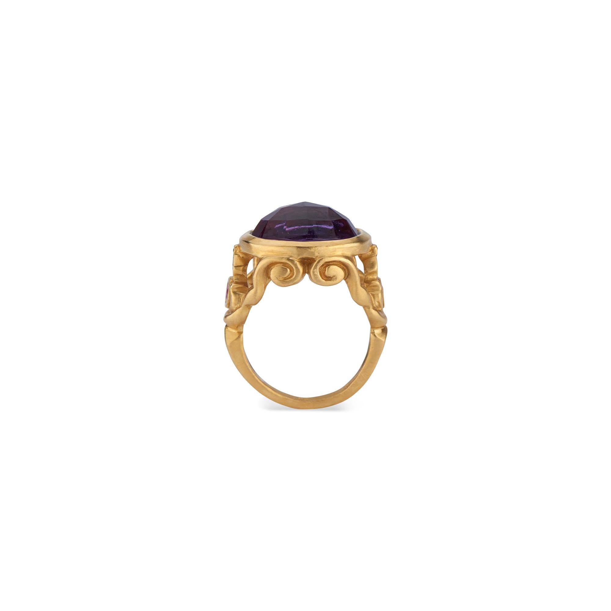 This exclusive Forge and Foundry design, features a large (.47 x .6 inches, 12 x 15 millimeter) oval rose-cut amethyst in 22k gold, accented with fuchsia sapphires (approximately .0833 total carat weight). The 22k gold with a matte finish provides a