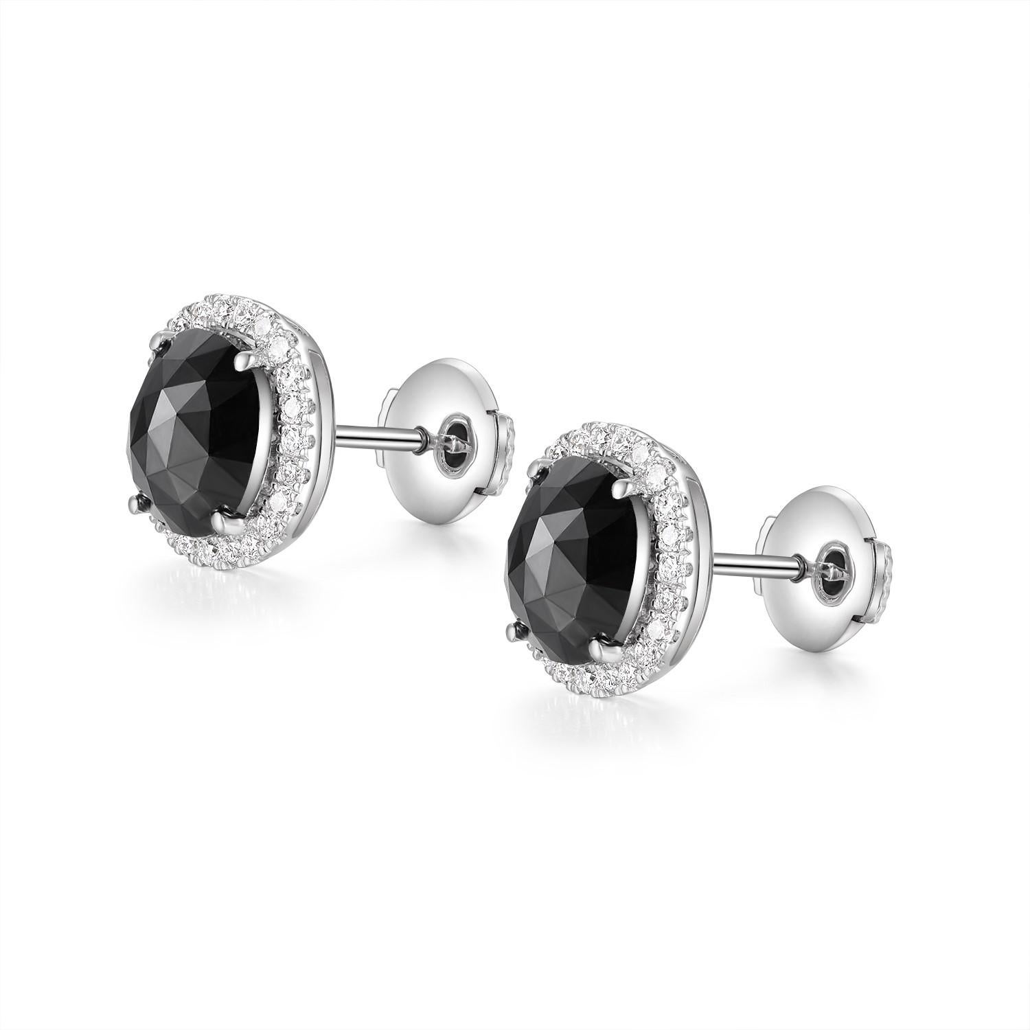 These sophisticated stud earrings present a striking combination of elegance and modern design, featuring 2.29 carats of rose-cut black diamonds at their core. Each diamond boasts a classic rose cut, which emphasizes the gem's natural sheen and