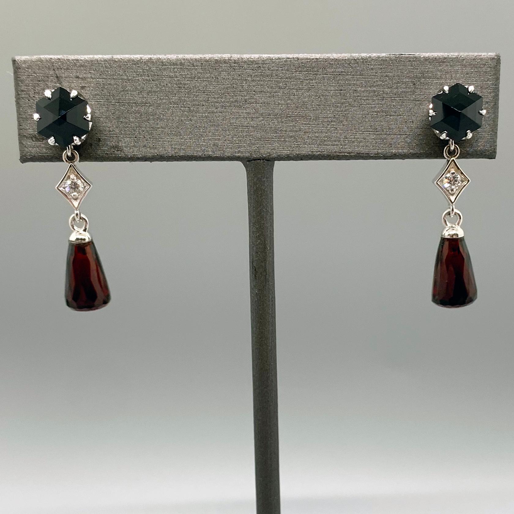A wealthy young woman slips down the stairs of her family home on a Friday evening in 1920s London. The dim lamplight catches on the fringe of her beaded dress and in the deep red garnet drops that hang from each ear. 

These earrings, nicknamed