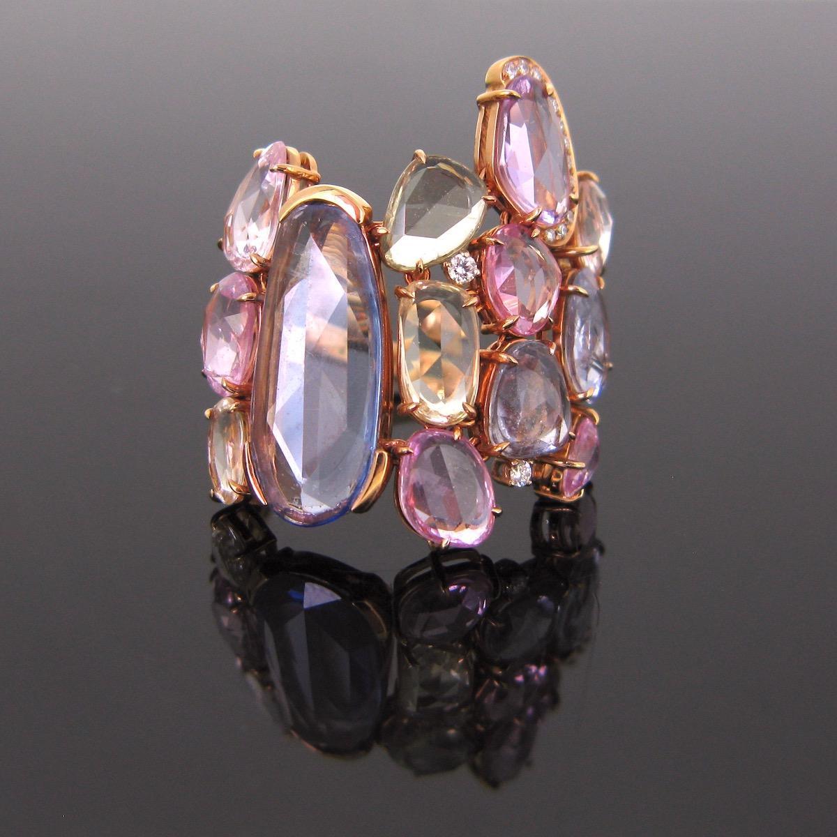 Weight : 10 gr

Stones : colored sapphires and diamonds

Metal : 18kt gold

Period : Modern

Condition : New

Hallmarks : UK / 750

A unique Colored sapphires and diamonds ring. This one has a unique design. It is adorned with rose cut colored