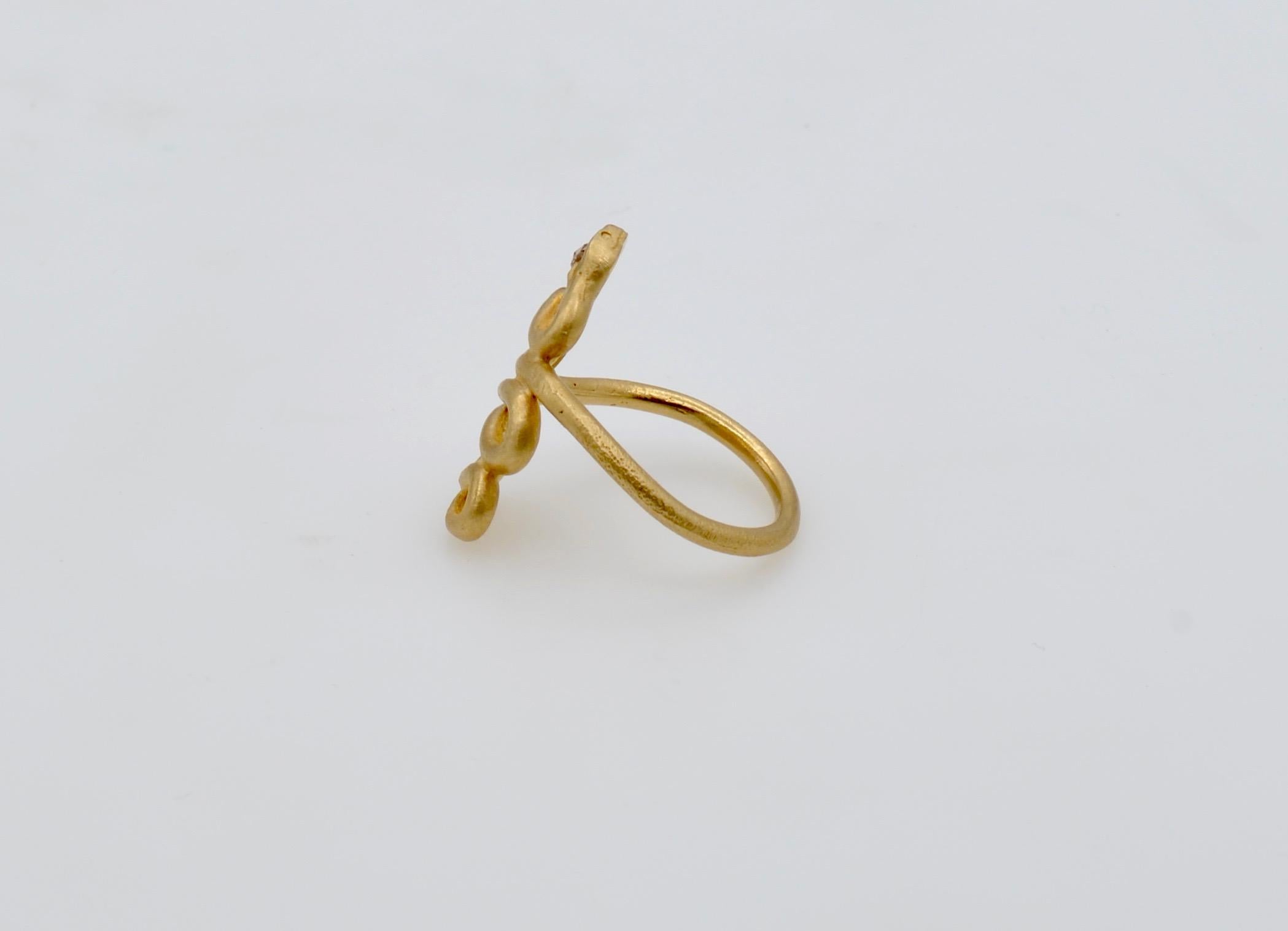 This snake ring is fun and fanciful. It has a 0.05 carat rose cut diamond in the head that has a beautiful sparkle offset by the matte finish of the yellow gold. The shape of the snake is elegant on the finger and is comfortable to wear. A beautiful