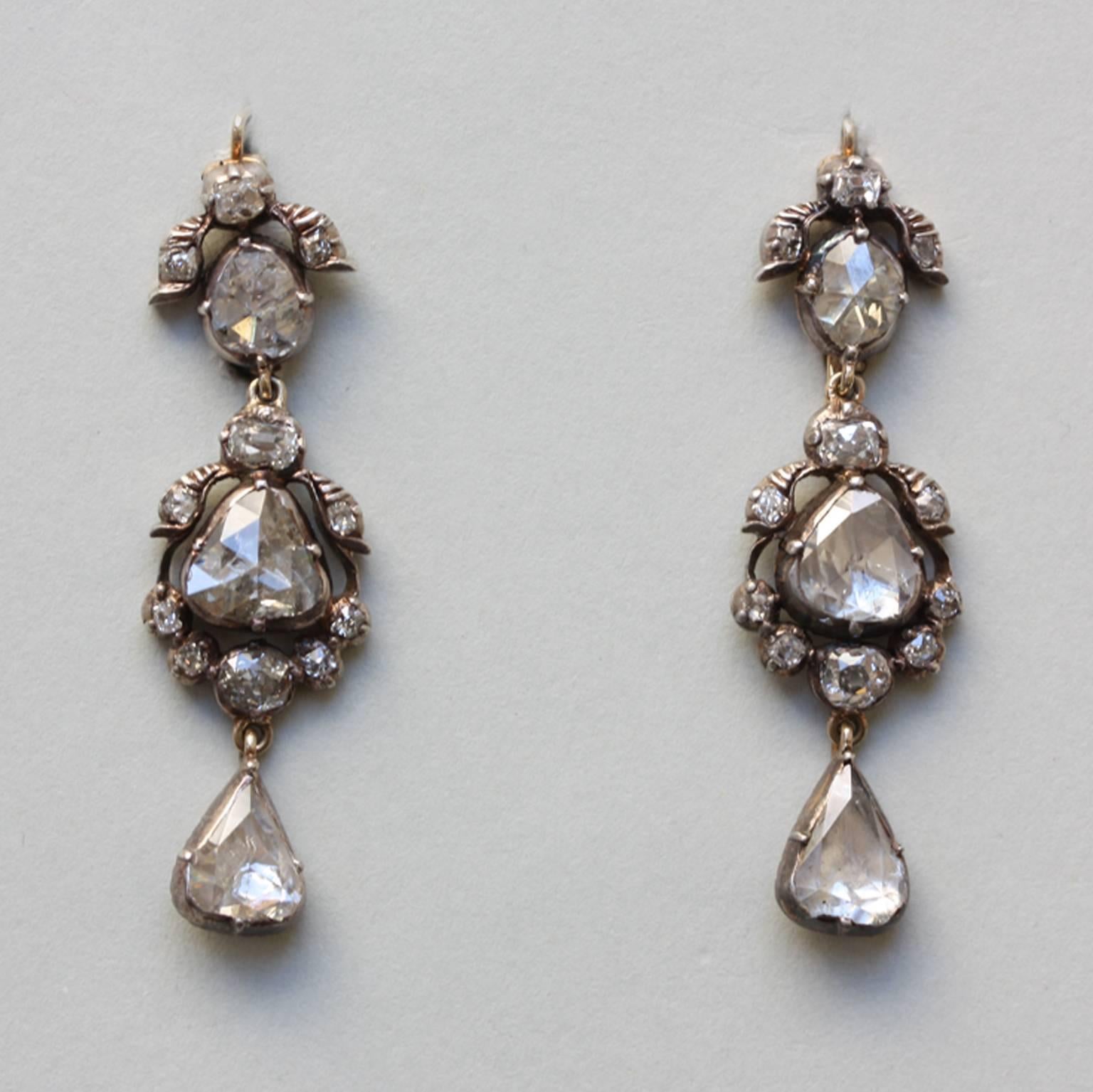 A pair of silver and gold earrings set with rose cut and cushion cut diamonds, gold hooks and gold backing, Dutch or German, 19th century.

weight: 7.08 grams
dimensions: 4.5 x 1.3 cm