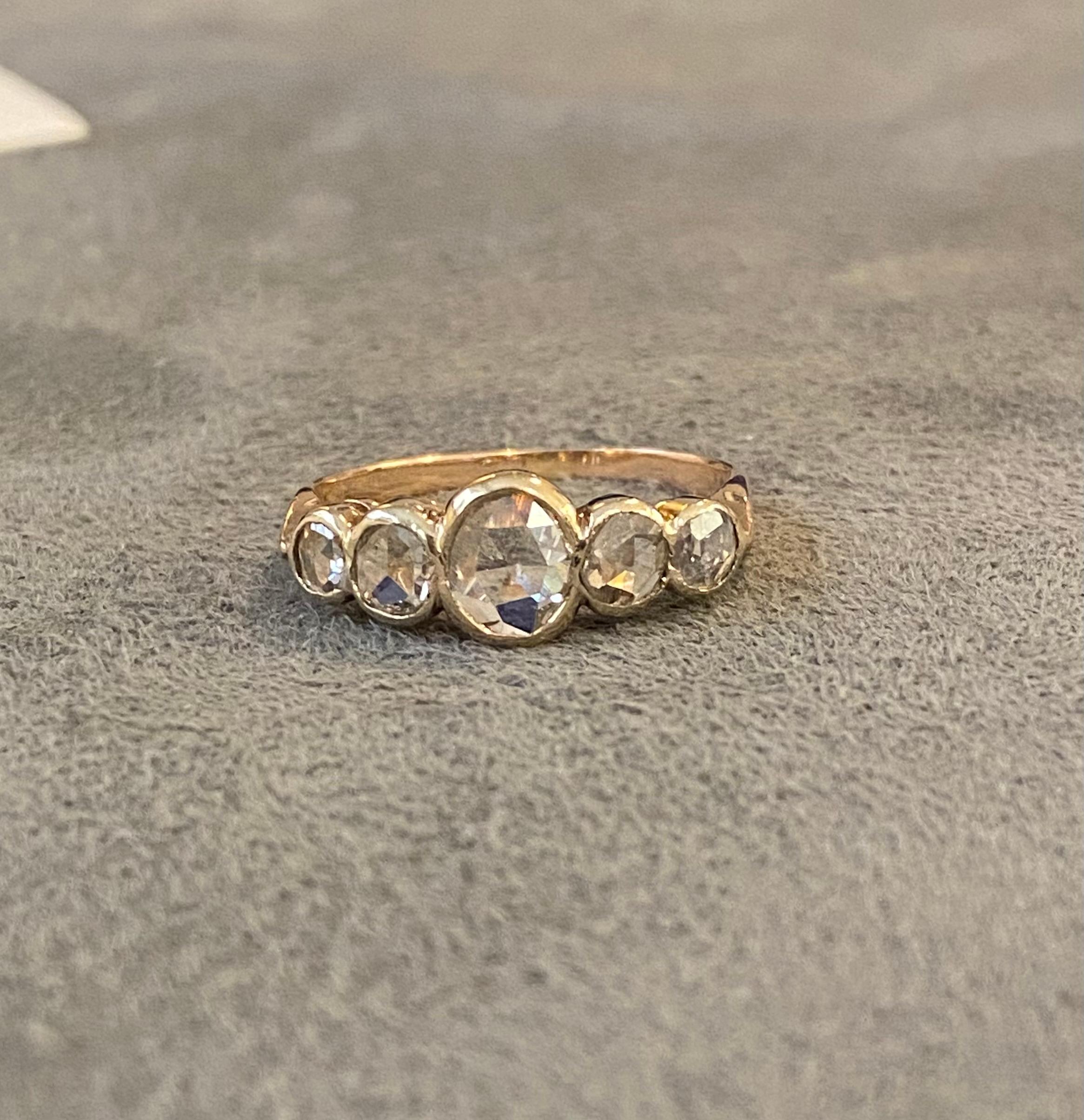 An 18k gold ring (probably antique) set with five rose cut diamonds (I1, O-P) of approximately 0.90 cts. 1886 and 1911 engraved inside ring. 