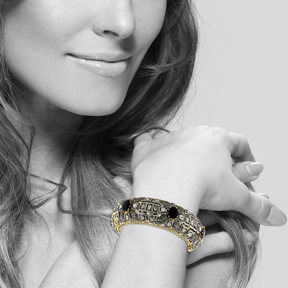 Bold and lovely this rosecut diamond and saphhire bangle is a piece forever. The floral motif and gold filigree going around this bangle makes a big statement bangle. 

14k: 36.37 g
Diamond: 7.15ct
Slv: 49.12gm
Sapphire: 20.07ct