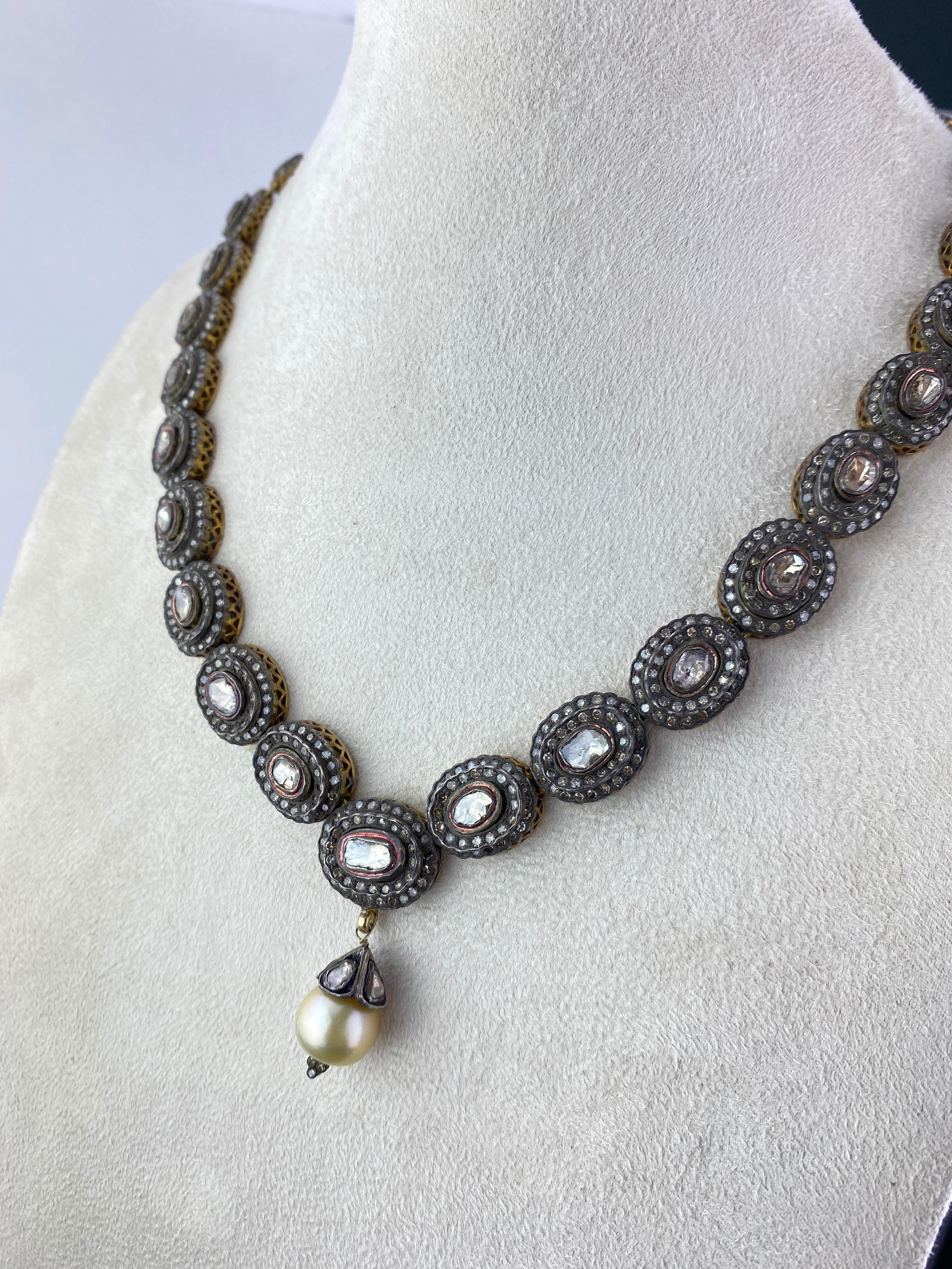 A classic Victorian style silver and gold Diamond necklace. The length of the chain is 19 inches, with a south sea pearl pendant hanging from it. 